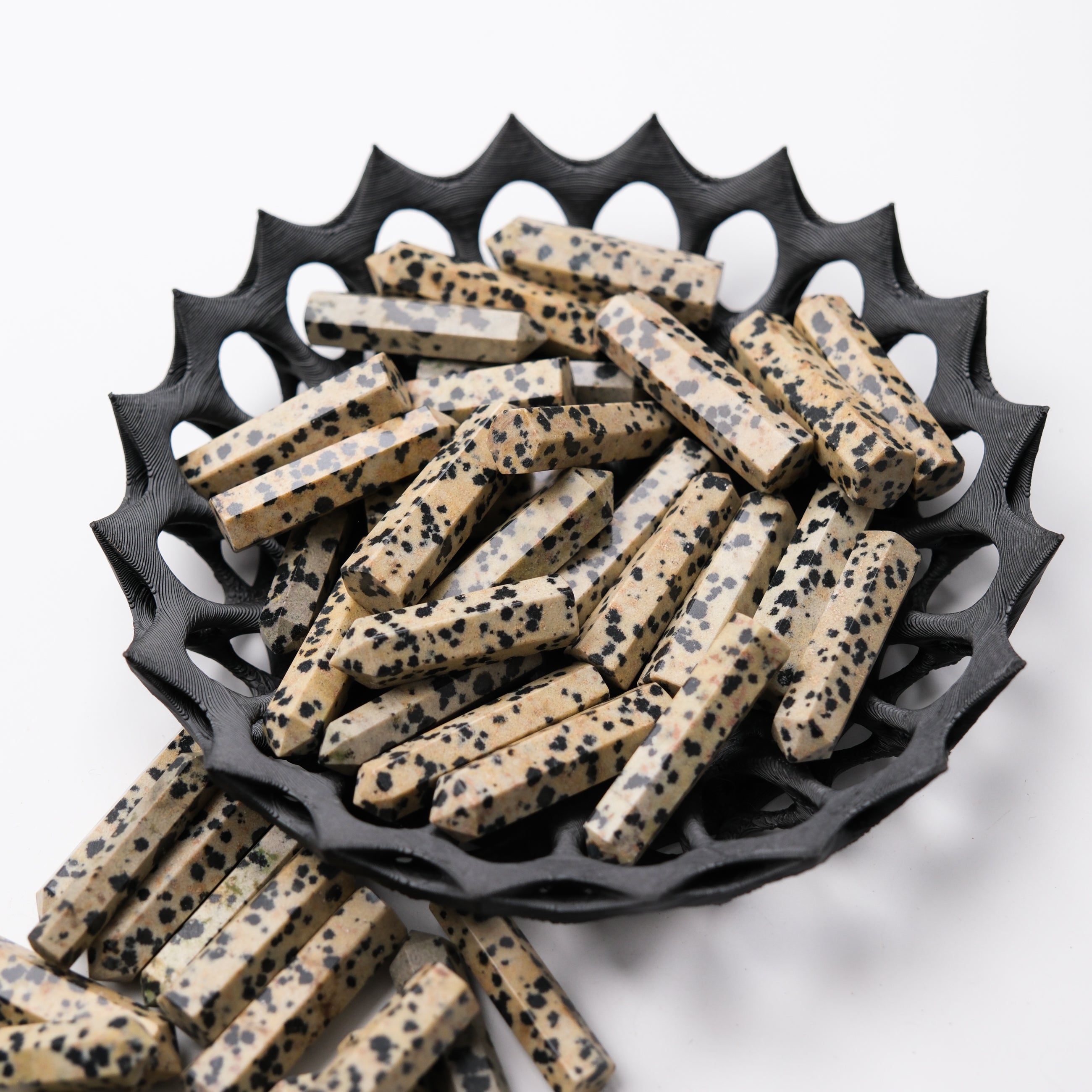 Dalmatian Jasper single gridding point from Noctis Studio, showcasing a polished stone with black and cream spots, ideal for crystal healing.
