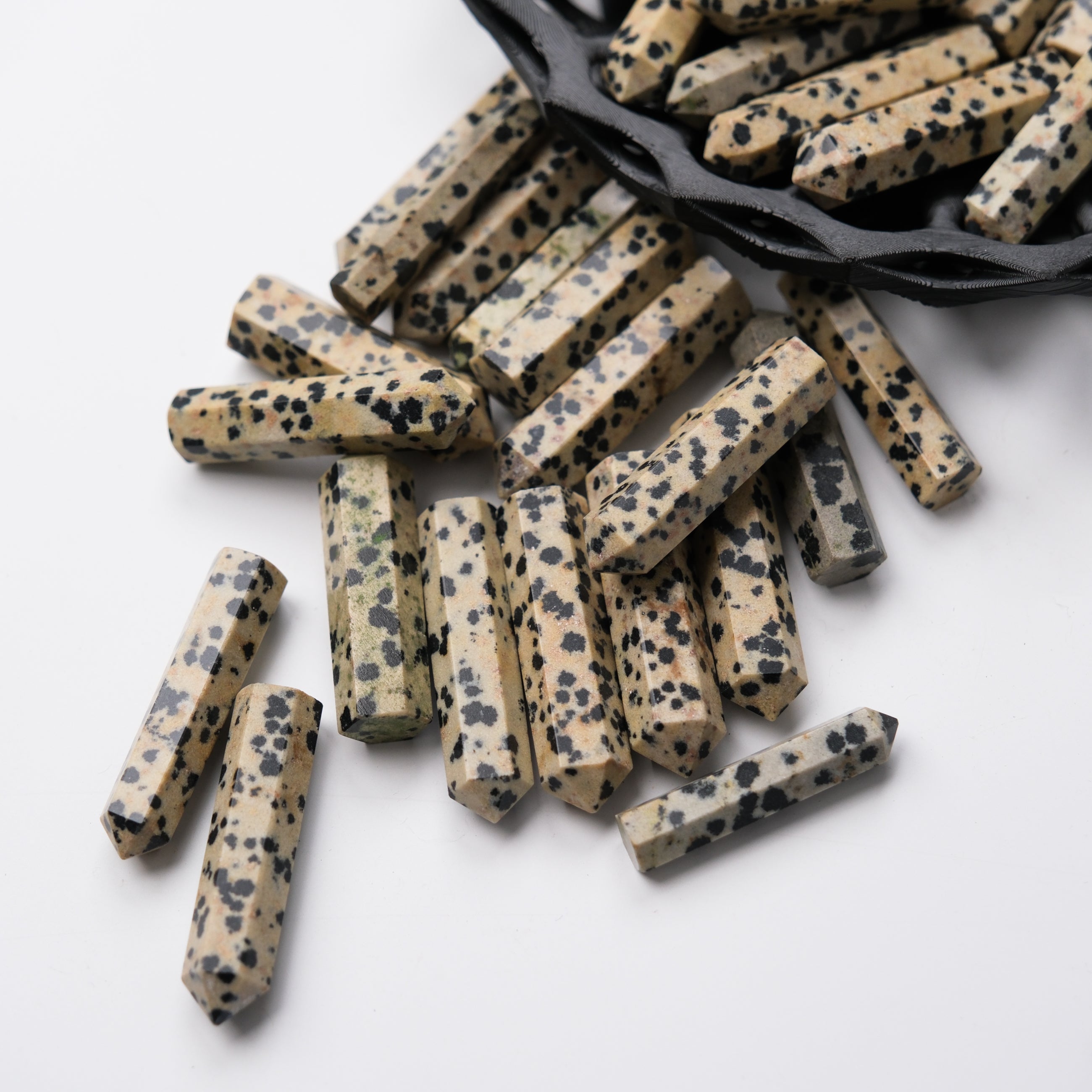 Dalmatian Jasper single gridding point from Noctis Studio, showcasing polished stone with black and cream spotted pattern.