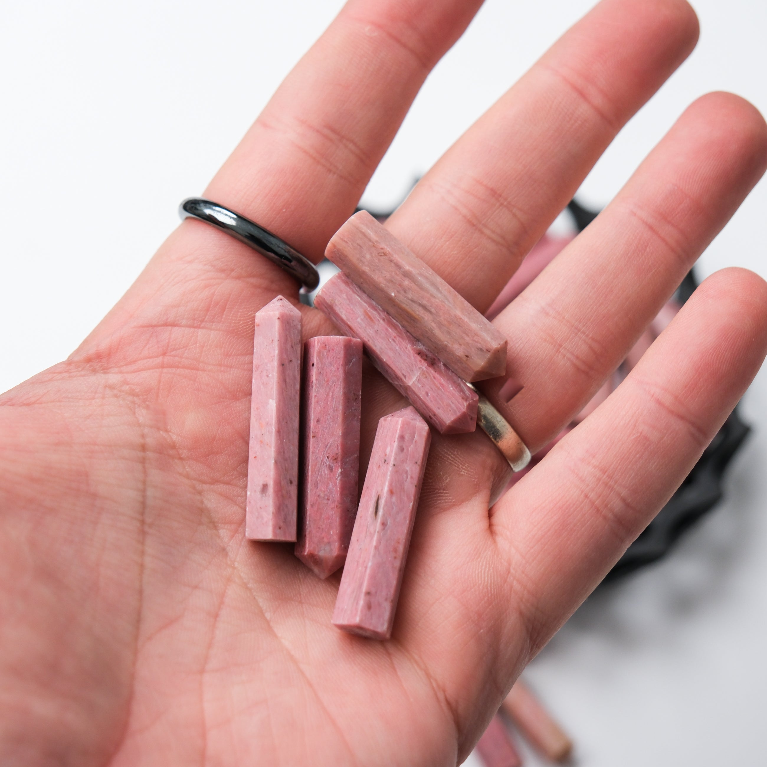 Pink petrified wood single gridding point by Noctis Studio, showcasing a polished, natural stone tool with a pointed tip.