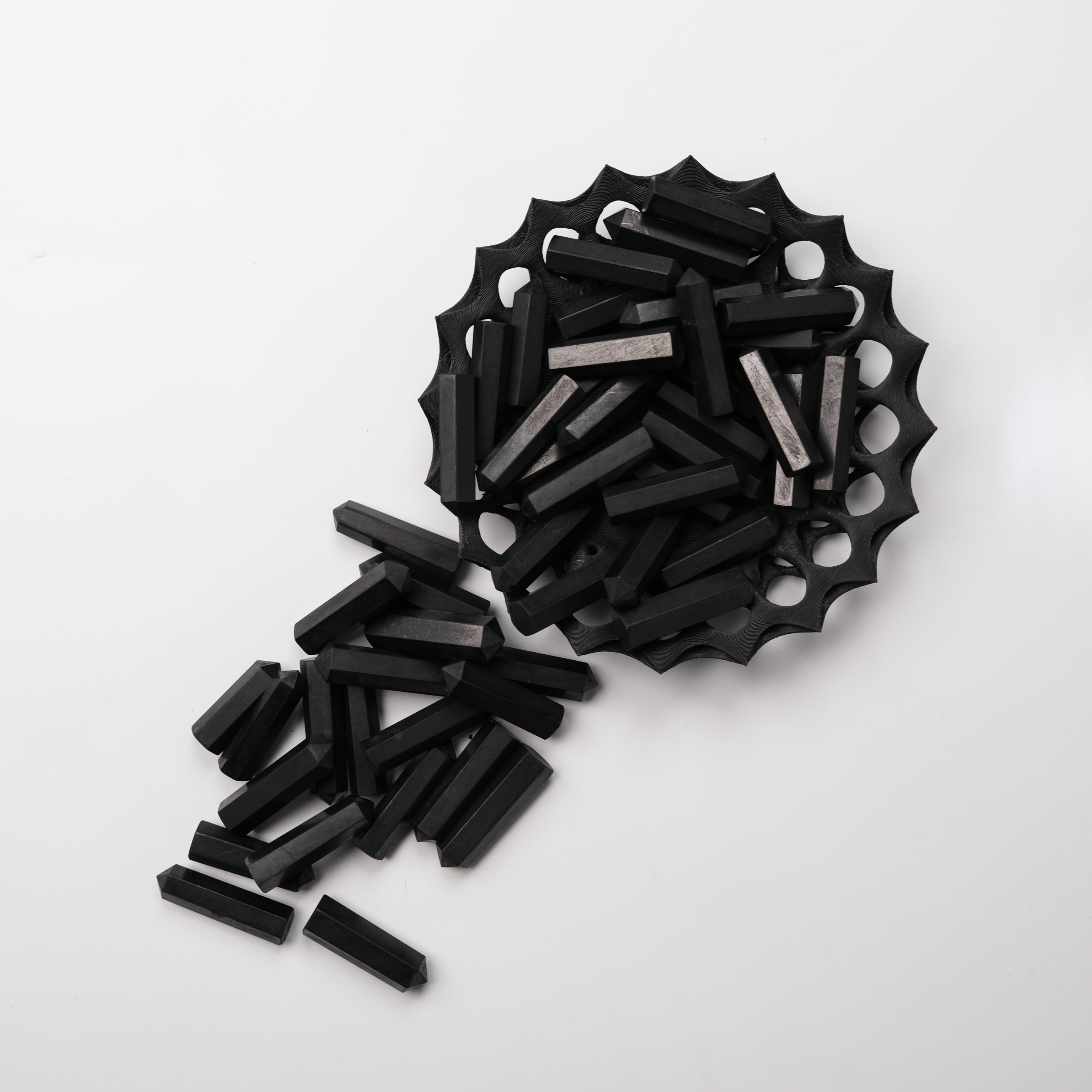 Shungite single gridding point from Noctis Studio, showcasing a polished black mineral crystal used for energy healing and spiritual practices.