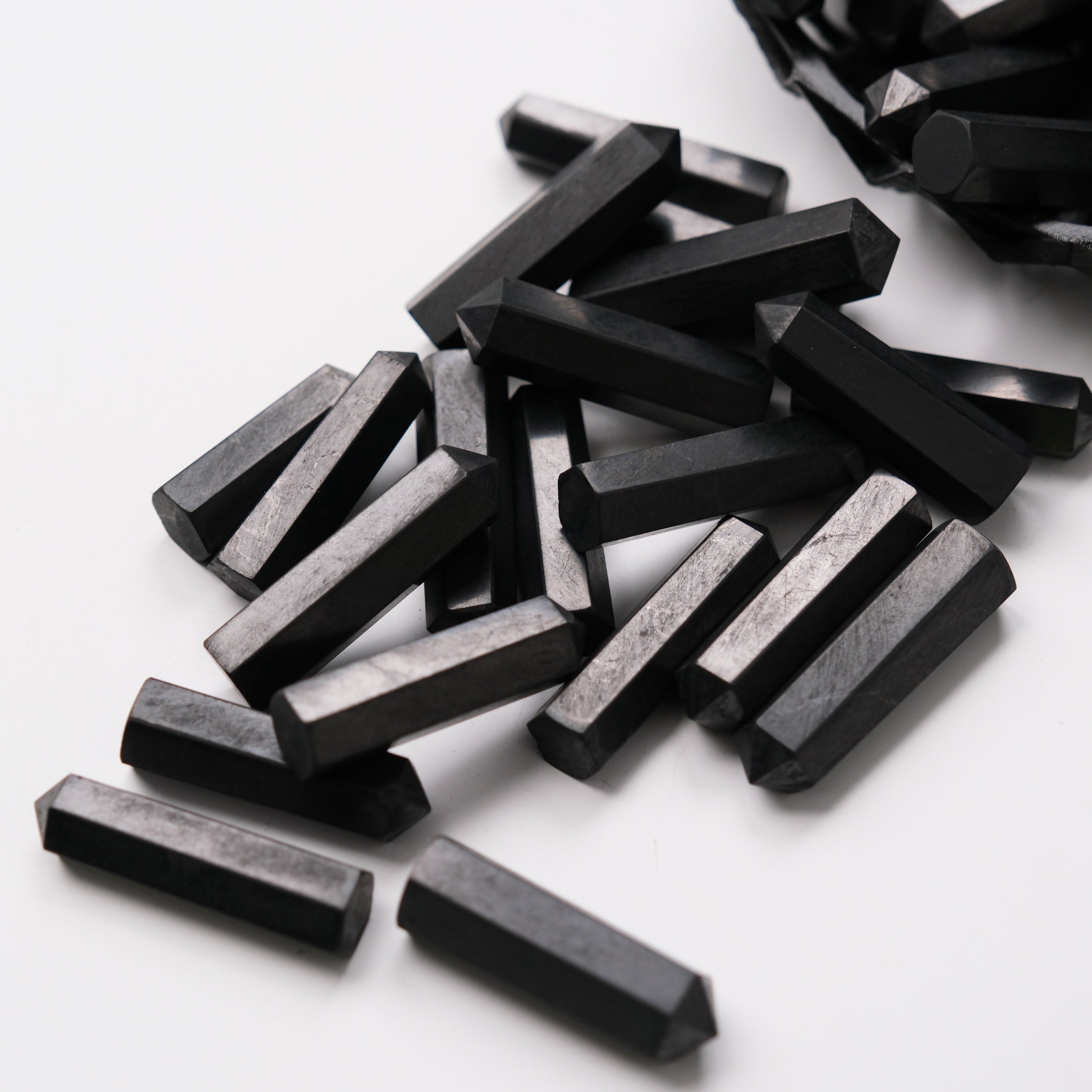 Shungite single gridding point by Noctis Studio, showcasing a dark, pyramid-shaped crystal used for energy work and healing.