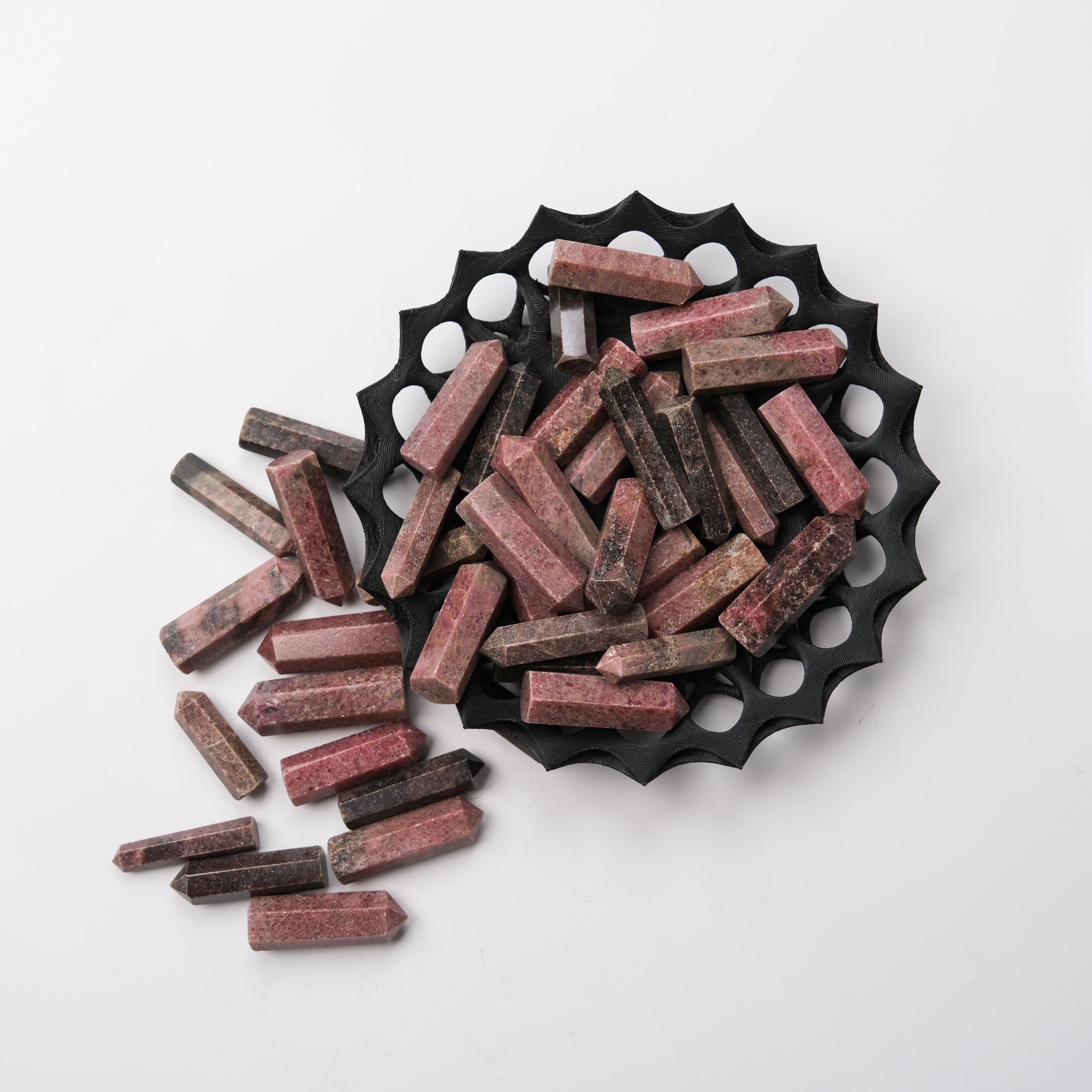 Rhodonite single gridding point from Noctis Studio, featuring polished pink and black stone with pointed tip for crystal healing.