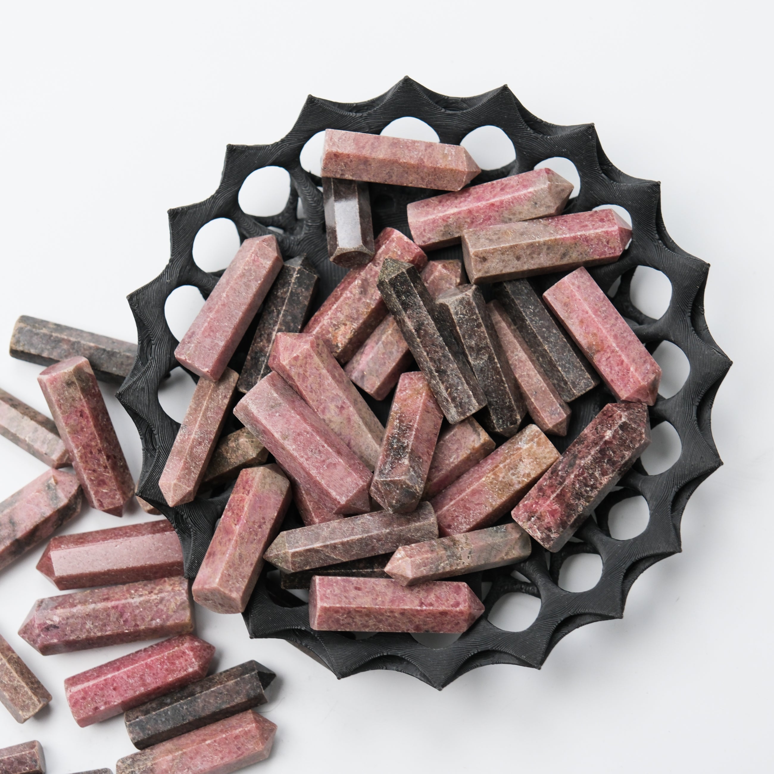 Rhodonite single gridding point by Noctis Studio, featuring a polished pink and black stone with pointed tip for crystal grid work.