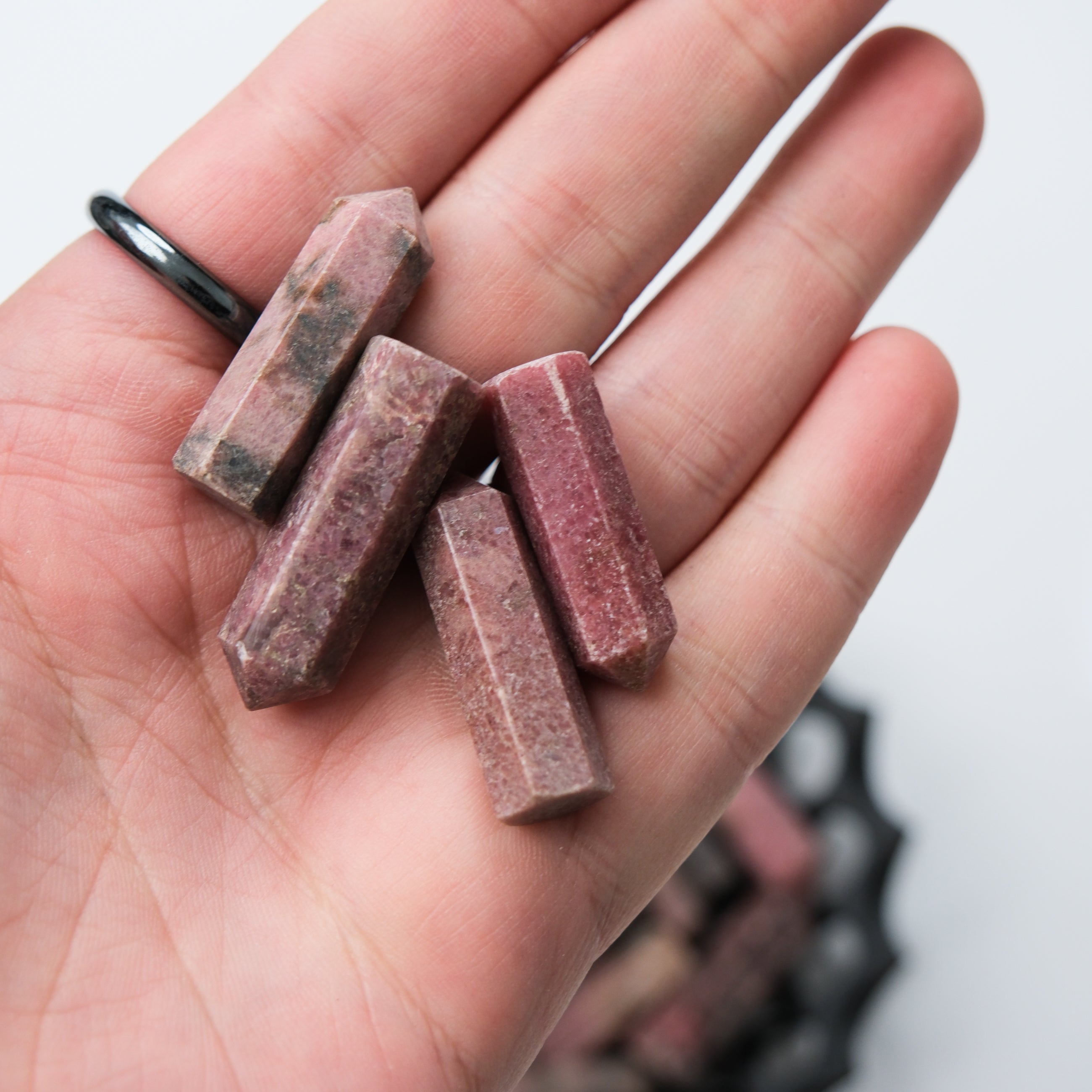 Rhodonite single gridding point by Noctis Studio, showing a polished pink and black stone tool for gemstone setting.