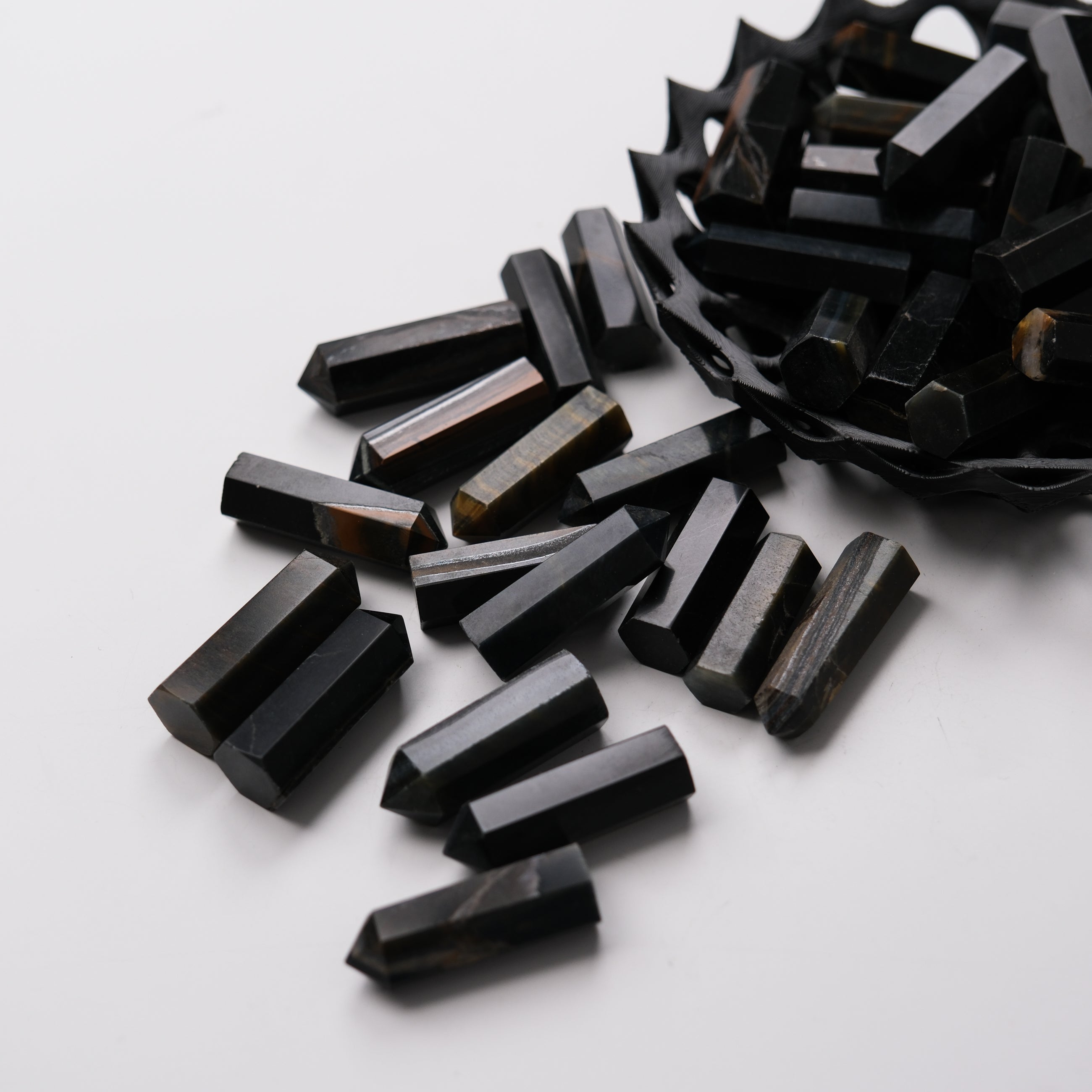 Blue Tigers Eye single gridding point from Noctis Studio, showcasing a polished gemstone with a pointed tip for jewelry making.