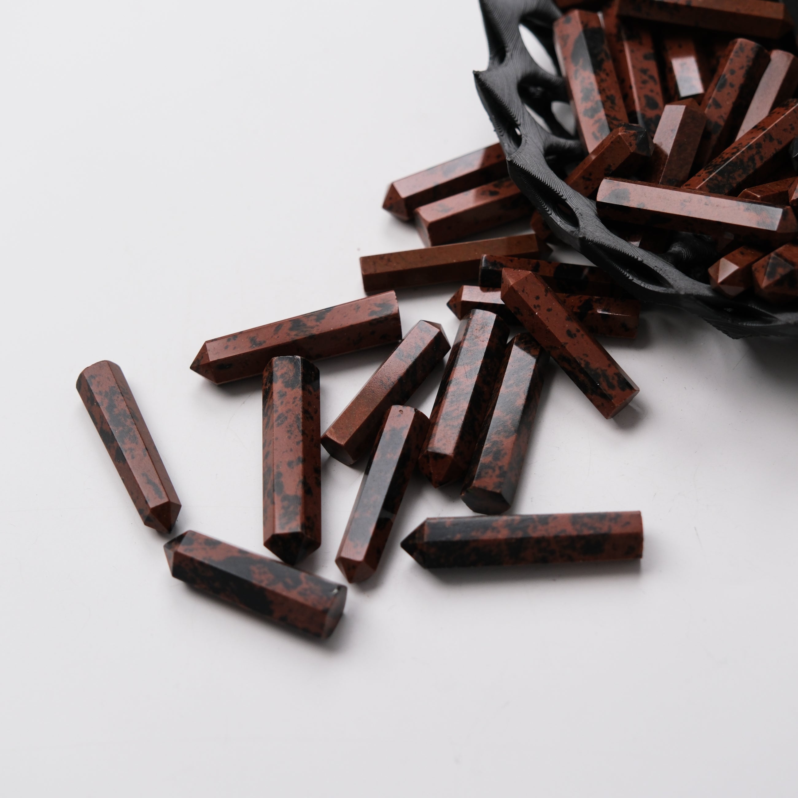 Noctis Studio Mahogany Obsidian Single Gridding Point showing a polished, pointed stone tool on a neutral background.