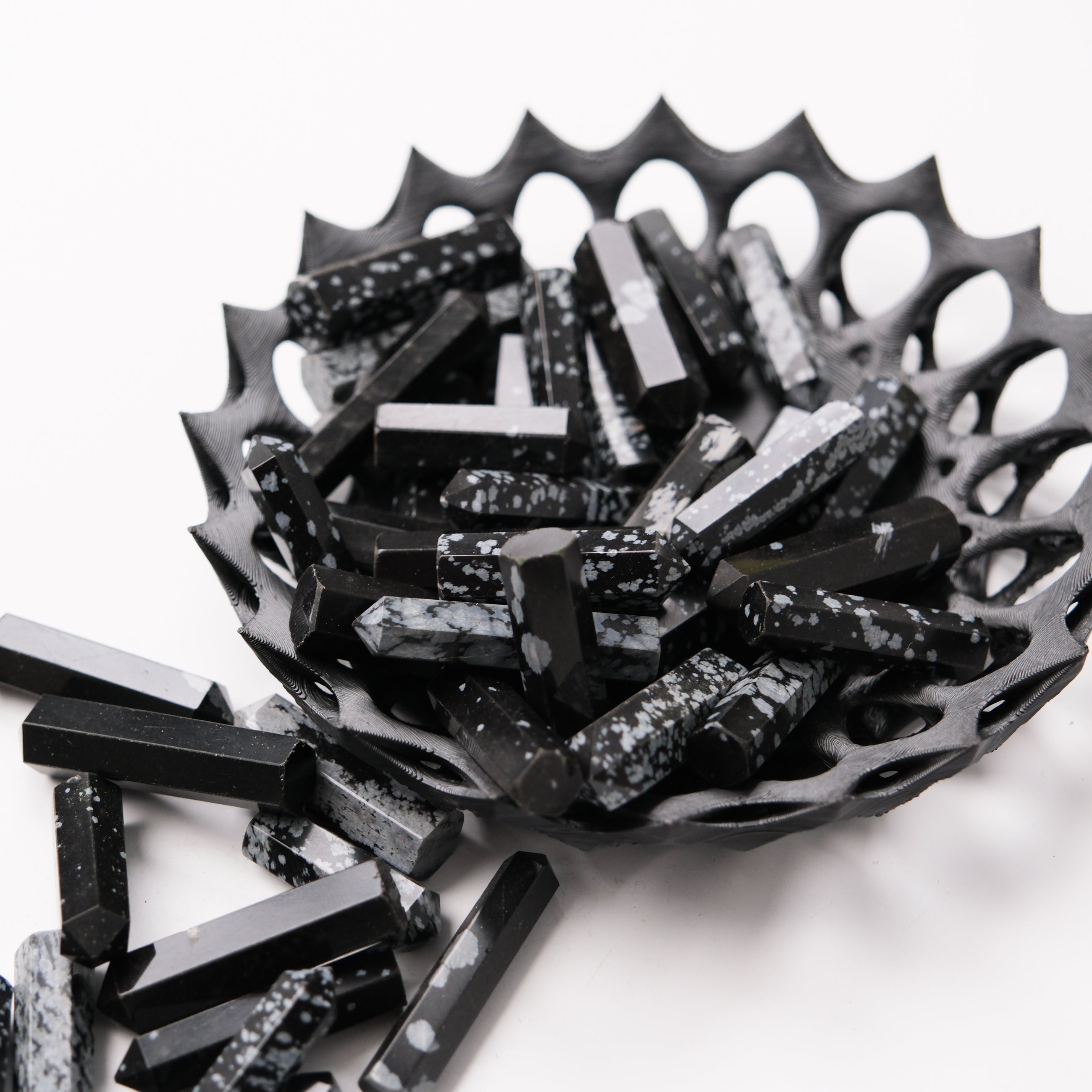 Snowflake Obsidian single gridding point from Noctis Studio, a polished crystal tool with intricate snowflake patterns for energy work.