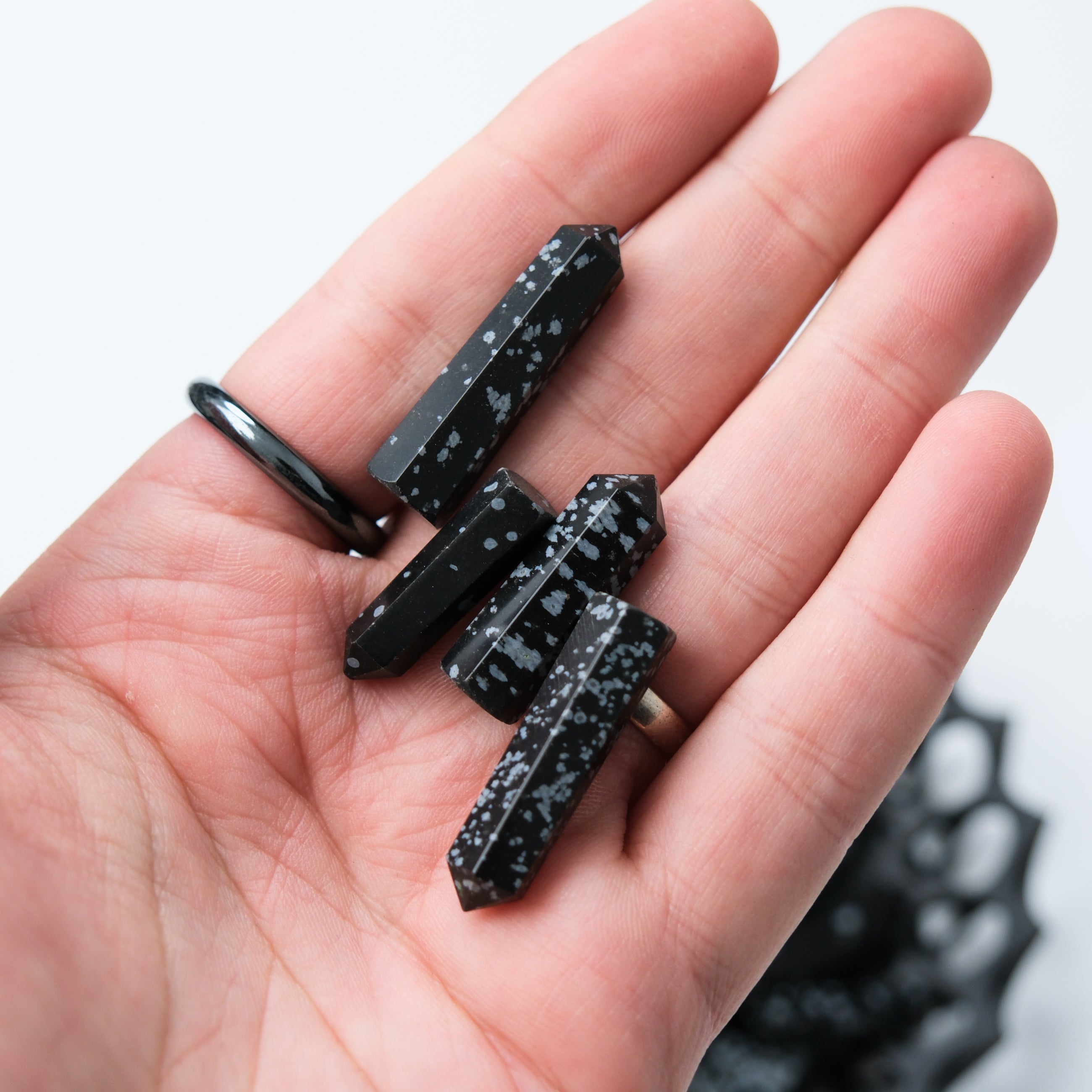 Noctis Studio Snowflake Obsidian single gridding point with pointed tip and polished finish on a plain background.