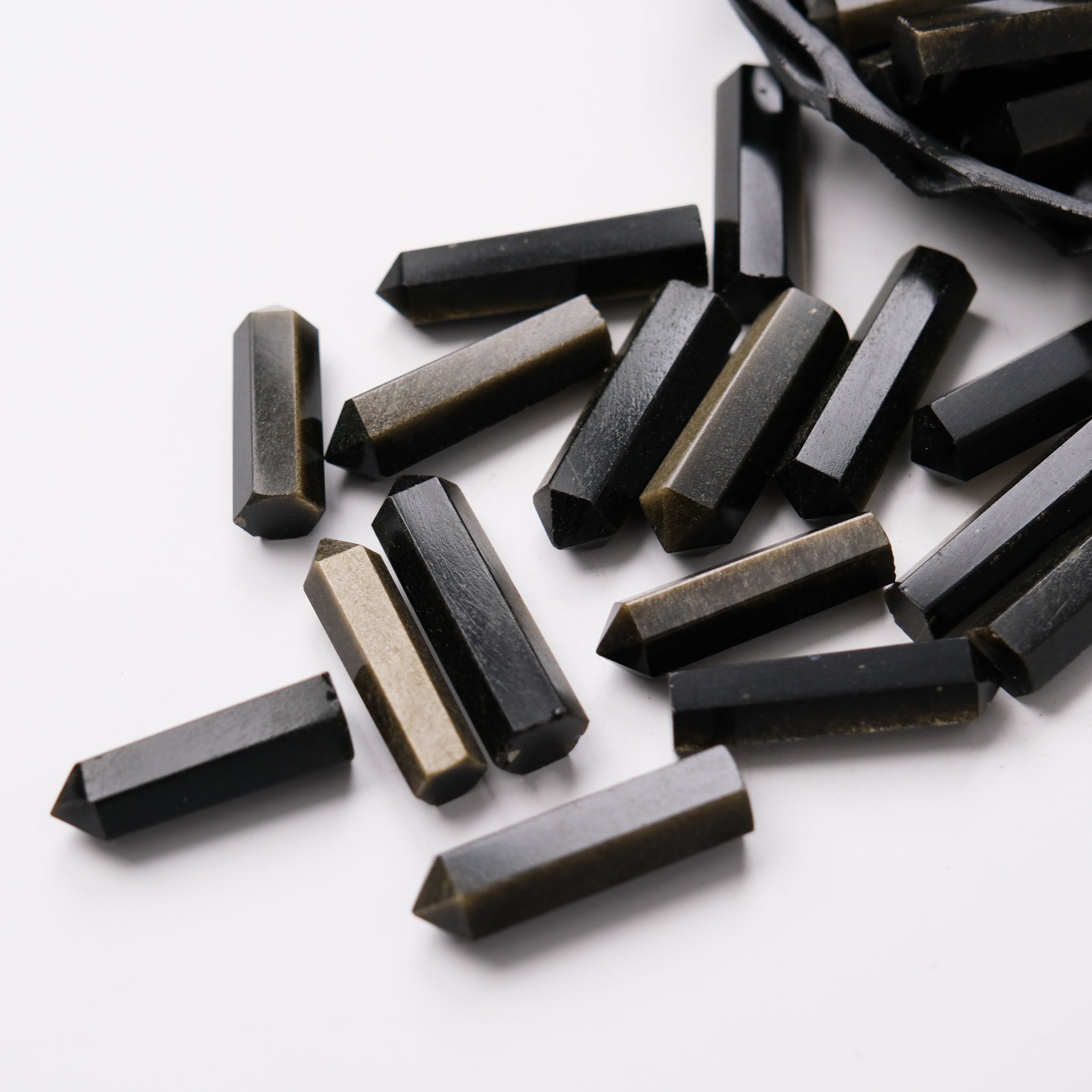 Golden Sheen Obsidian single gridding point by Noctis Studio, showcasing a polished, pointed gemstone for crystal grid work.