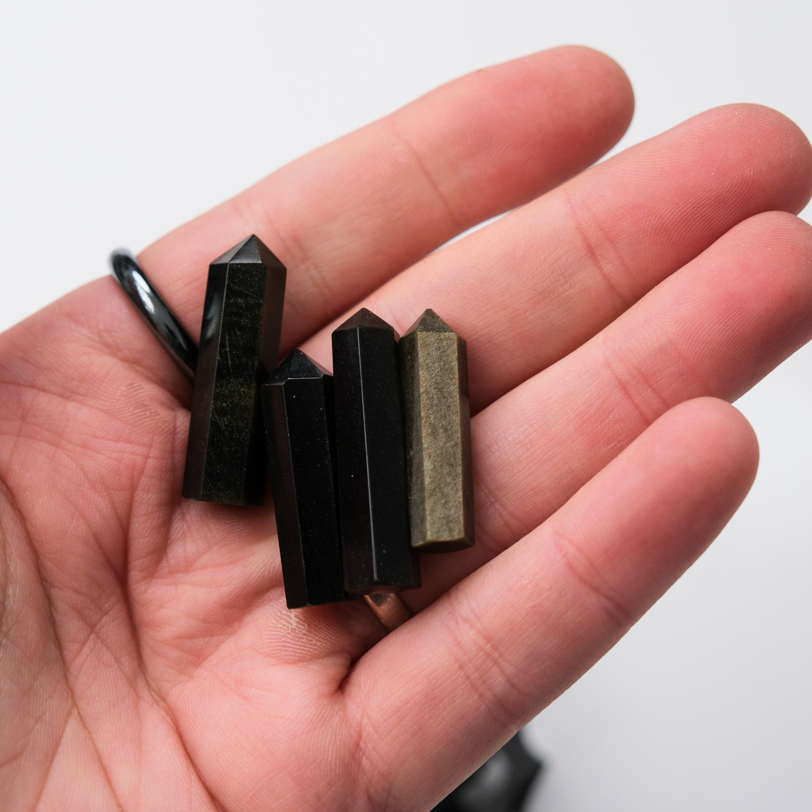 Golden Sheen Obsidian single gridding point by Noctis Studio, featuring a polished golden sheen and pointed tip for precise crystal grid placement.