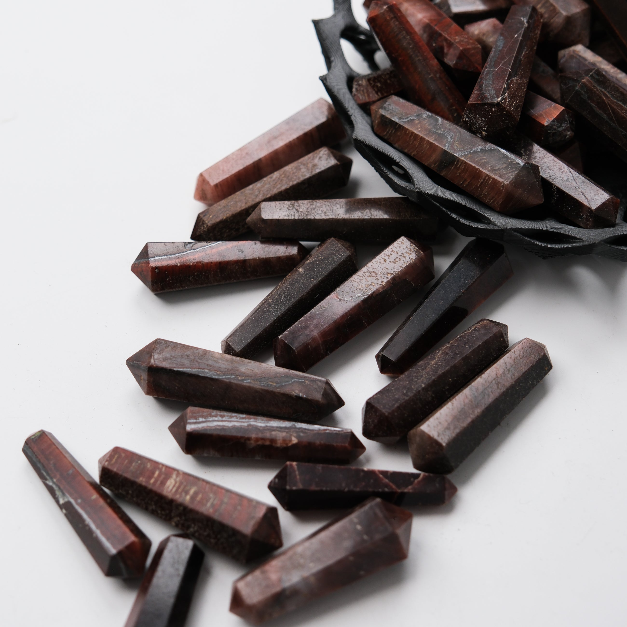 Red Tigers Eye double gridding point from Noctis Studio, showing a polished gemstone tool with detailed red and brown patterns.