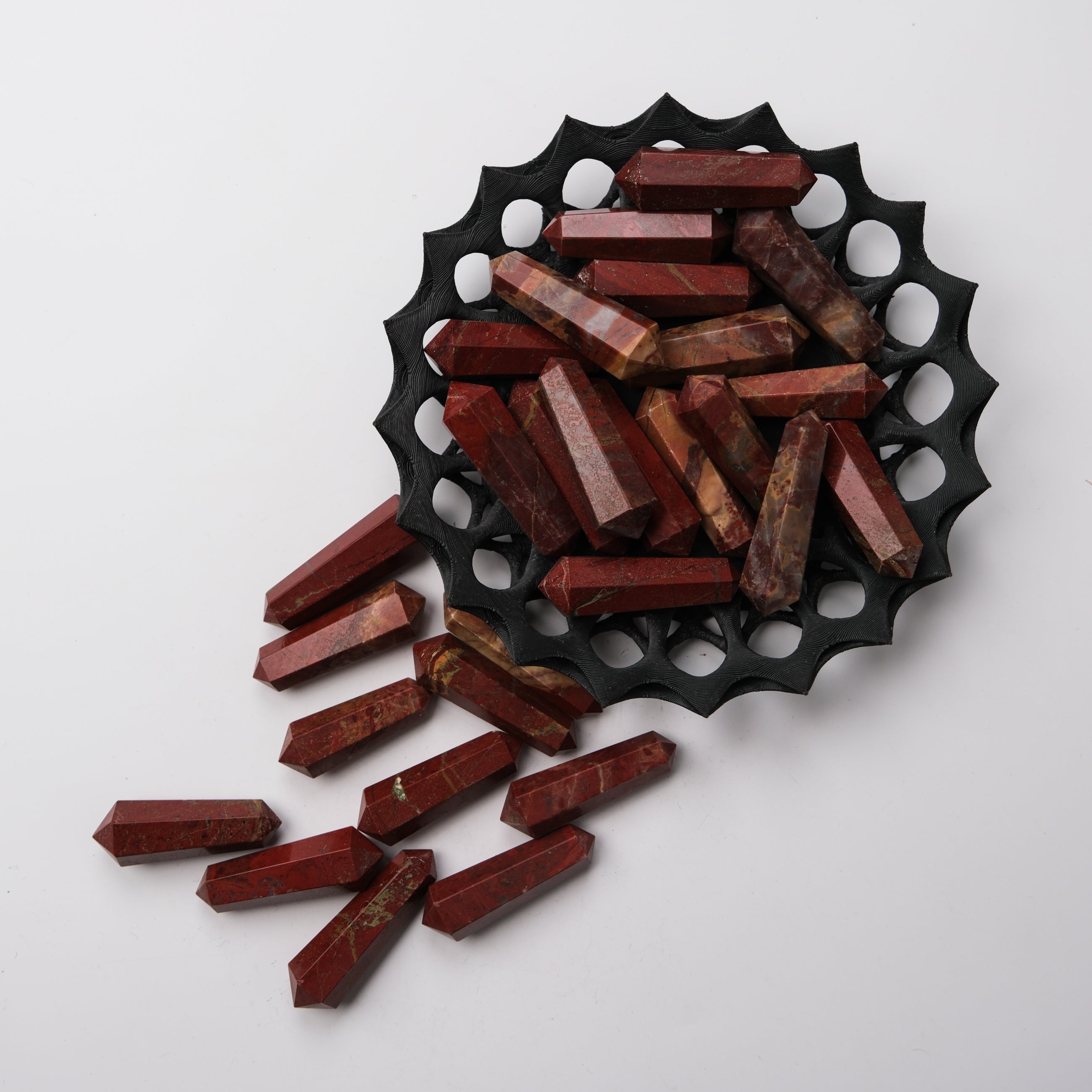 Red Jasper Double Gridding Point from Noctis Studio, showcasing a polished gemstone with intricate double-sided shaping.