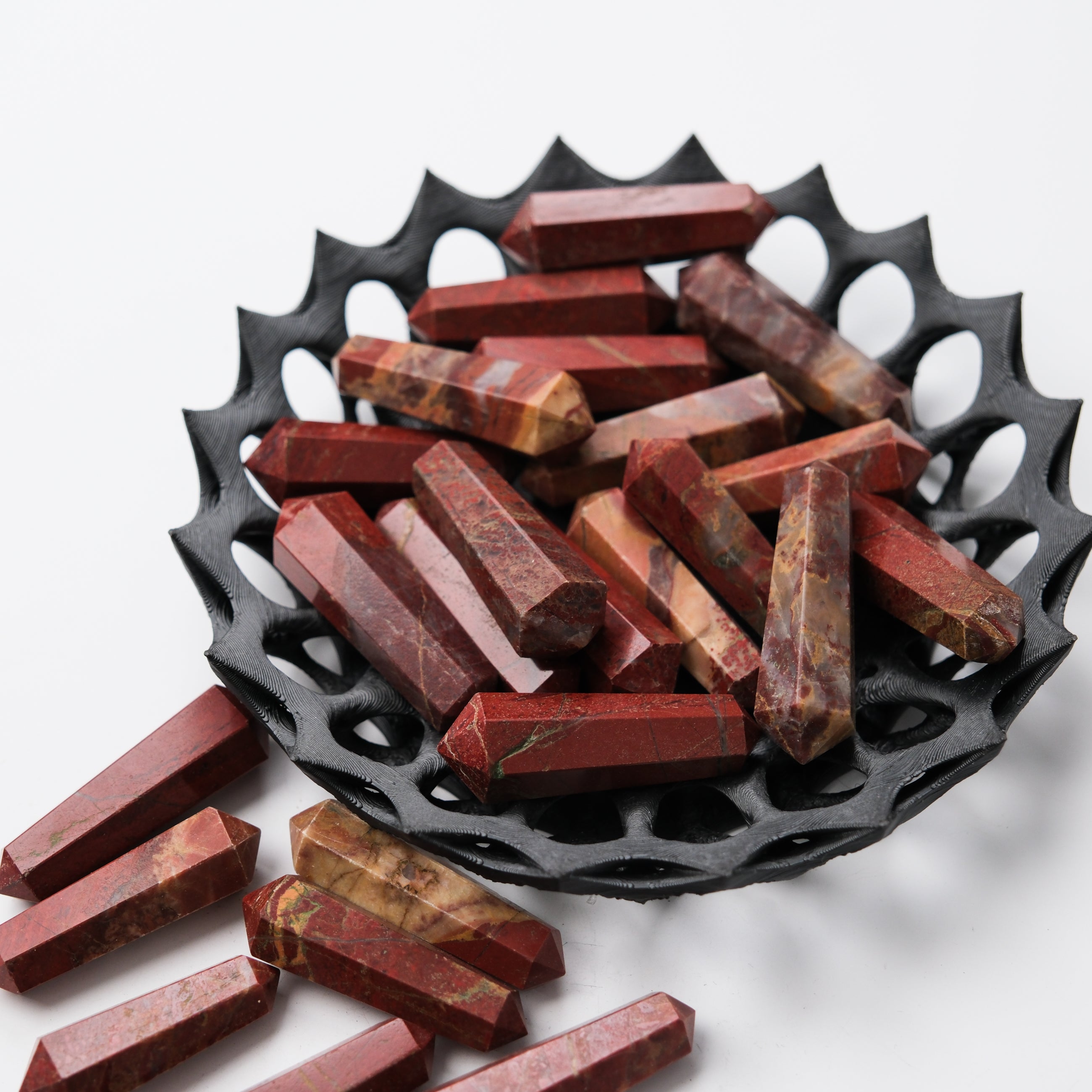 Red Jasper double gridding point from Noctis Studio, featuring polished red stone with detailed carving and pointed tip for jewelry making.