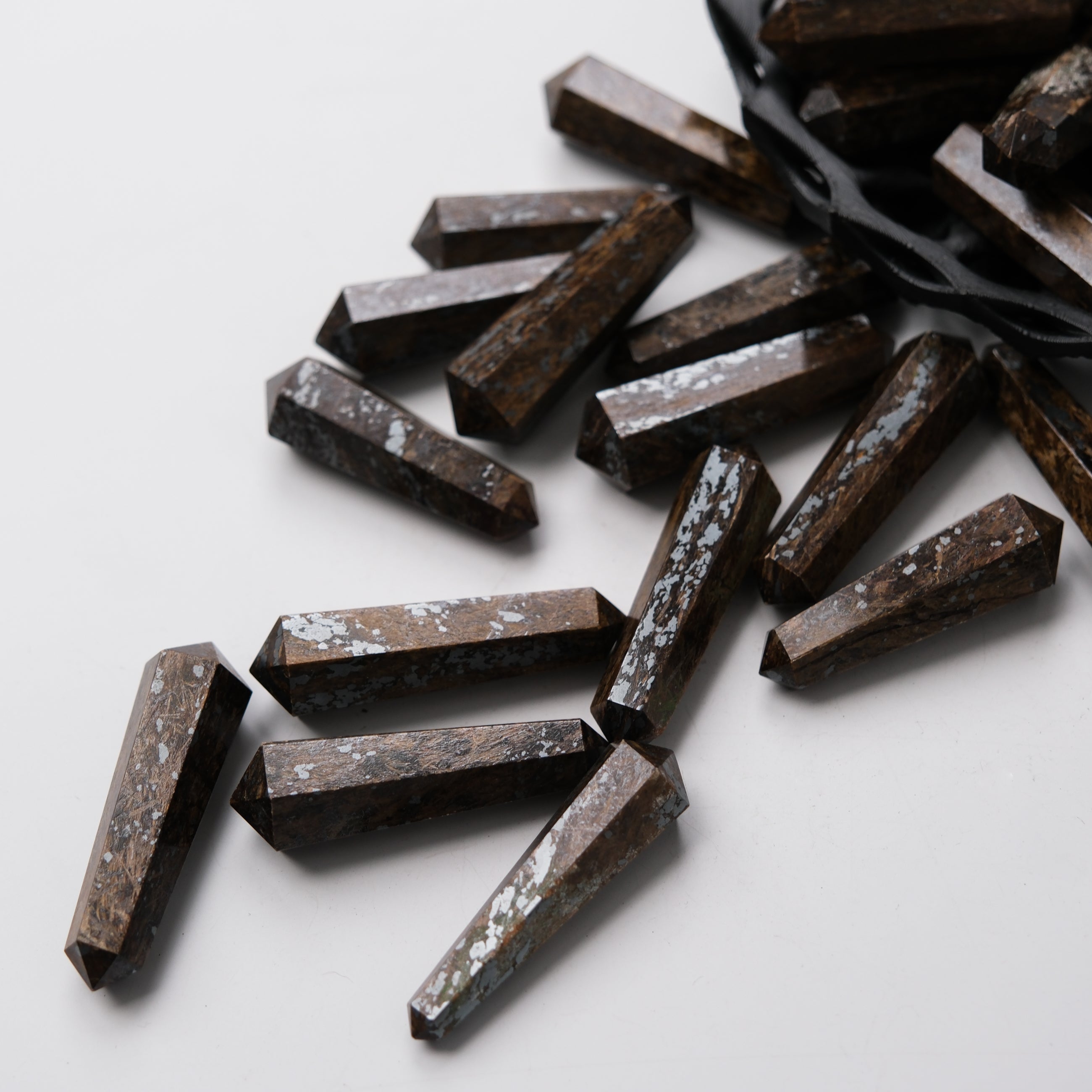 Bronzite double gridding point from Noctis Studio, featuring a polished, pointed gemstone ideal for jewelry making or crafting.