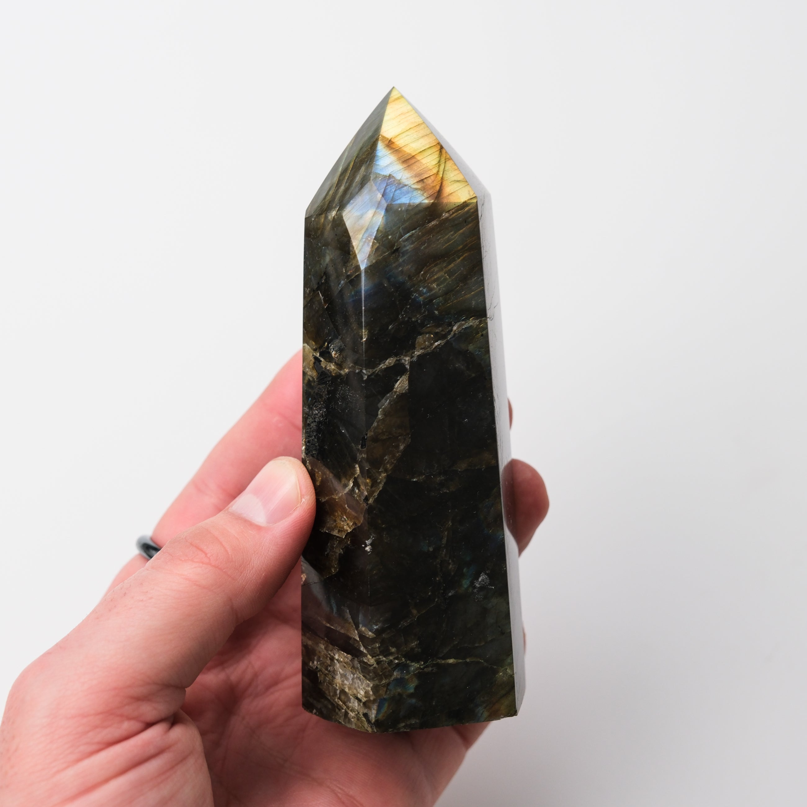 Labradorite pillar sculpture by Noctis Studio, showcasing iridescent gray and blue hues with smooth, polished surface.
