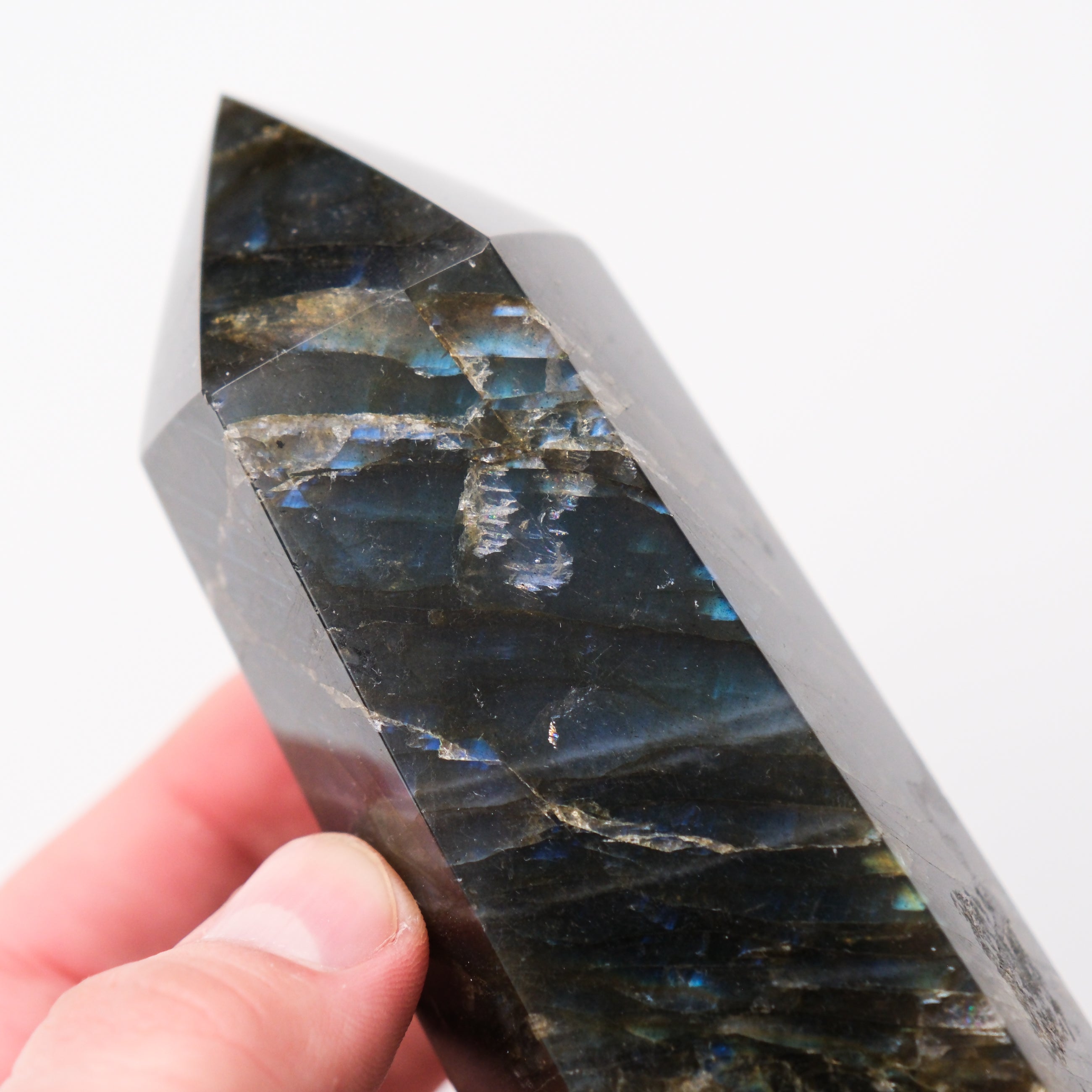 Labradorite pillar crystal sculpture by Noctis Studio, showcasing iridescent gray and blue hues with a polished, natural stone finish.