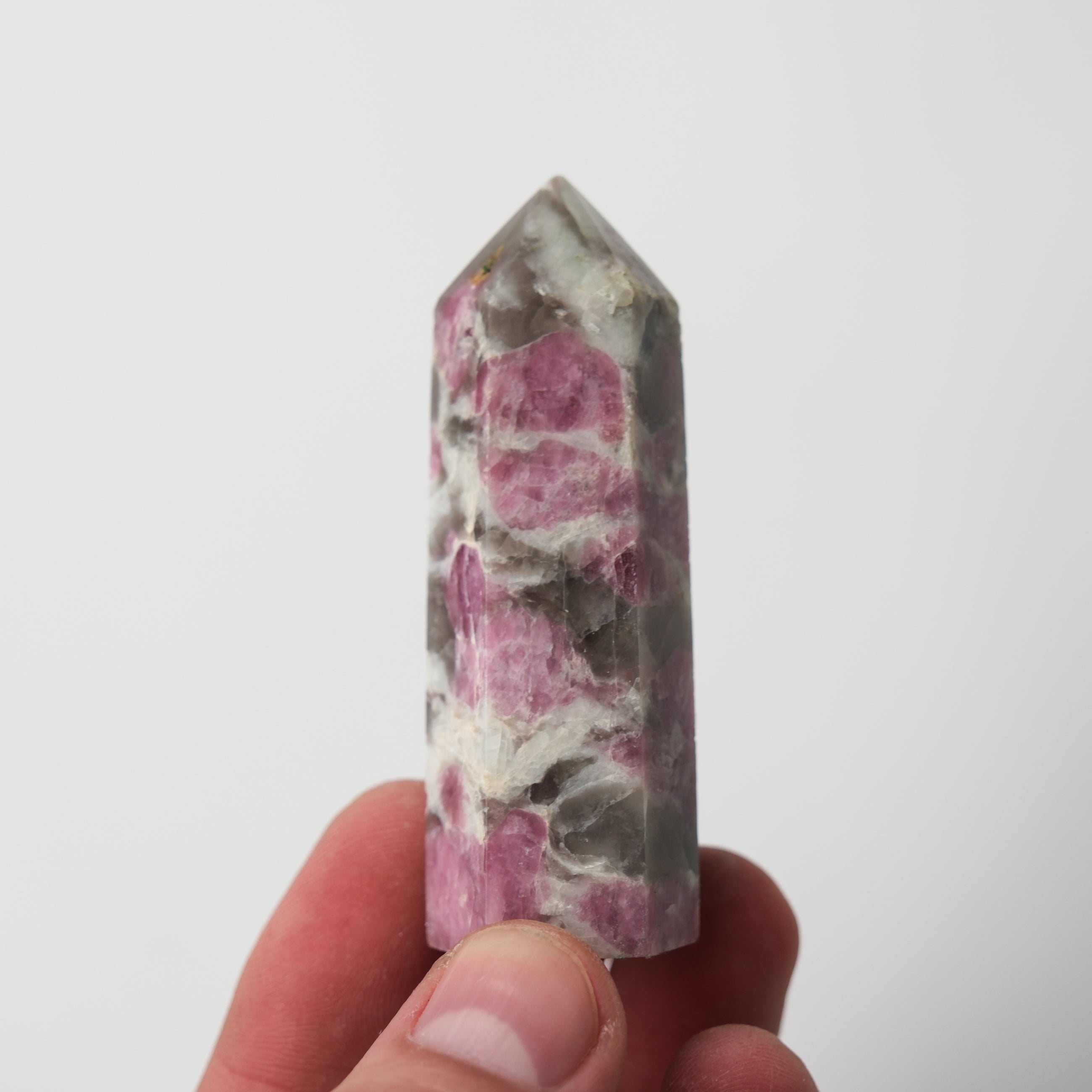 Pink tourmaline point pillar gemstone by Noctis Studio, showcasing a vibrant pink crystal with natural facets and a polished finish.