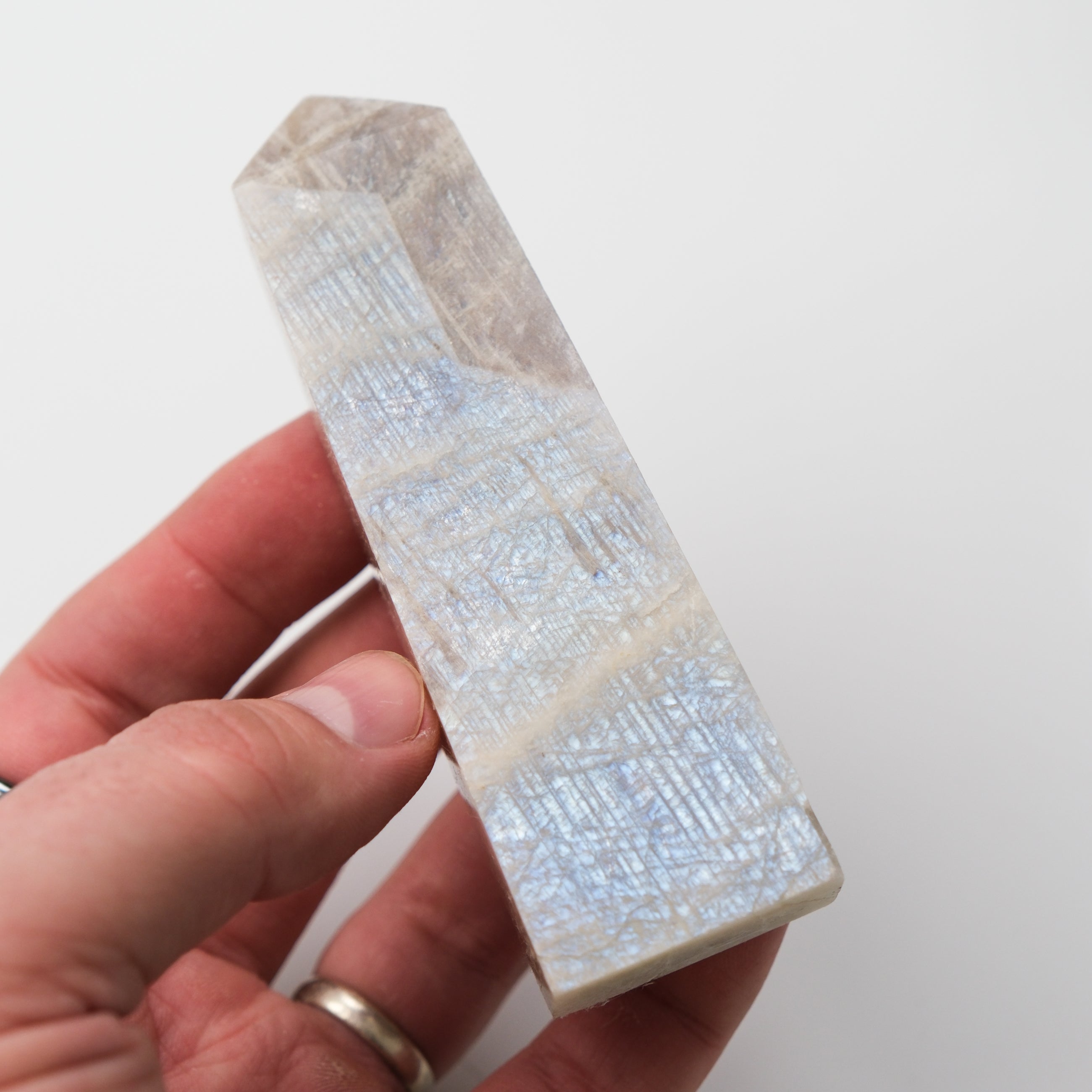 Cream Moonstone point pillar sculpture by Noctis Studio, smooth polished gemstone with soft cream and iridescent shimmer.