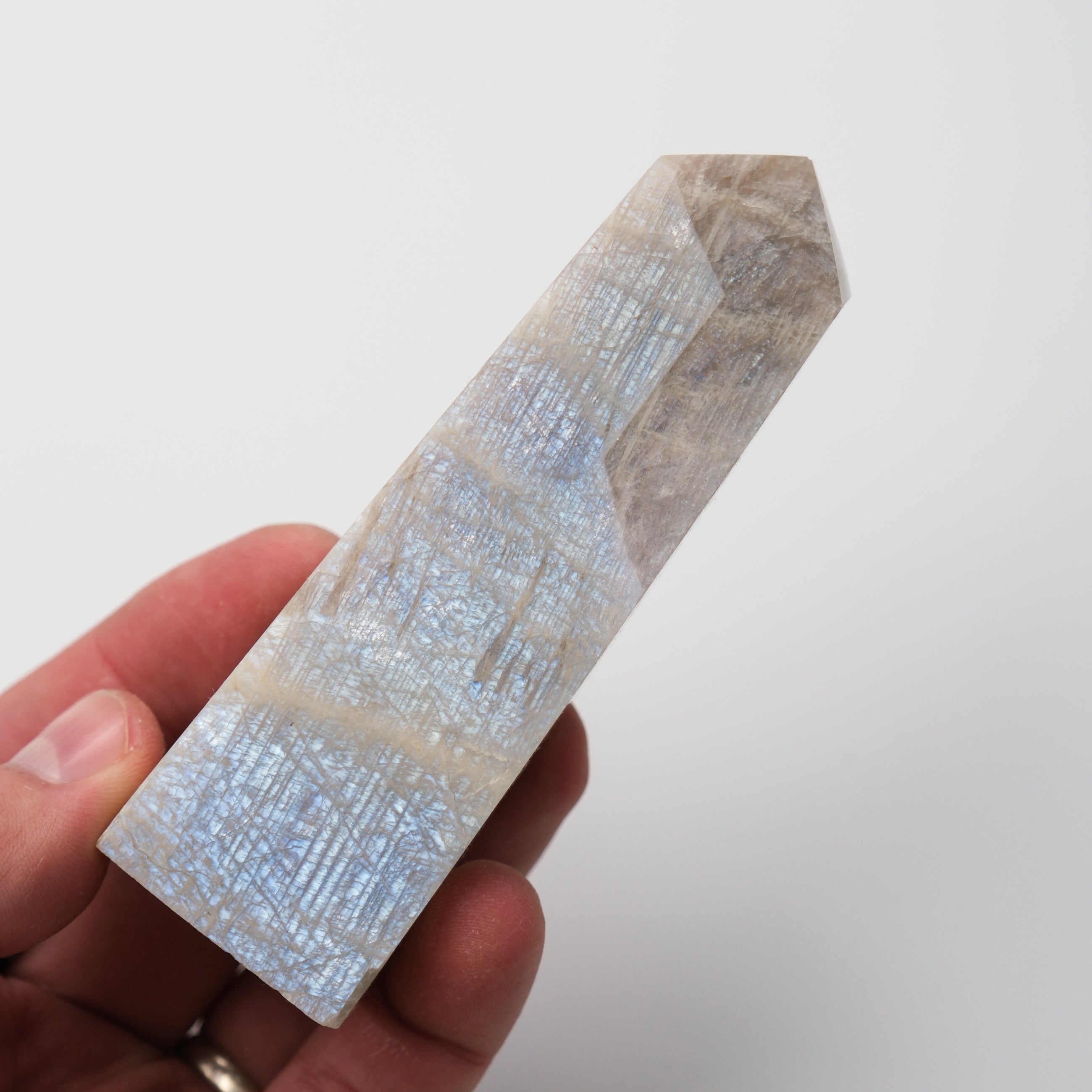 Cream Moonstone Point pillar crystal from Noctis Studio, showcasing a smooth, polished cream-colored moonstone with natural striations.