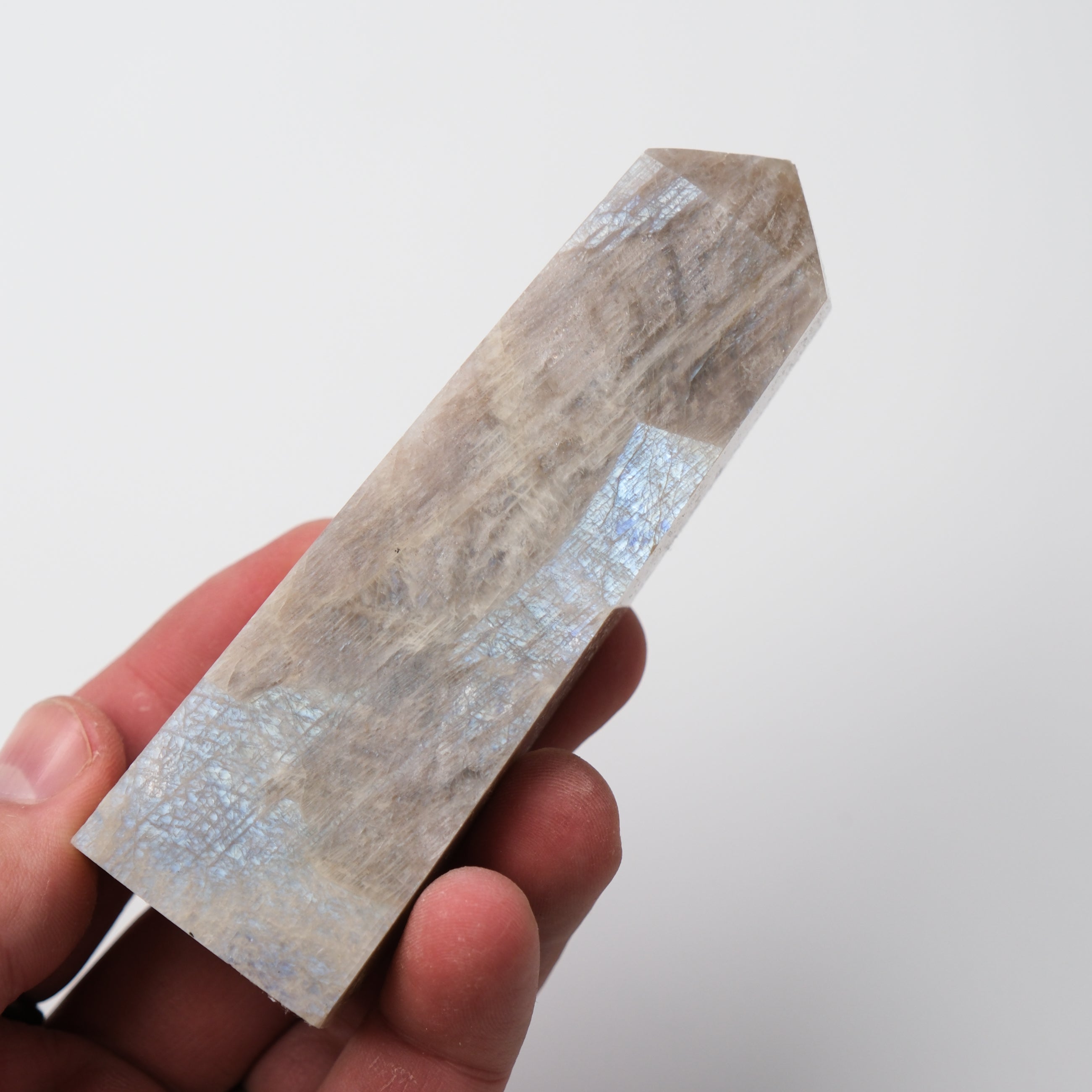Cream Moonstone Point pillar sculpture by Noctis Studio, showcasing a smooth, polished moonstone with a gentle glow and natural veining.