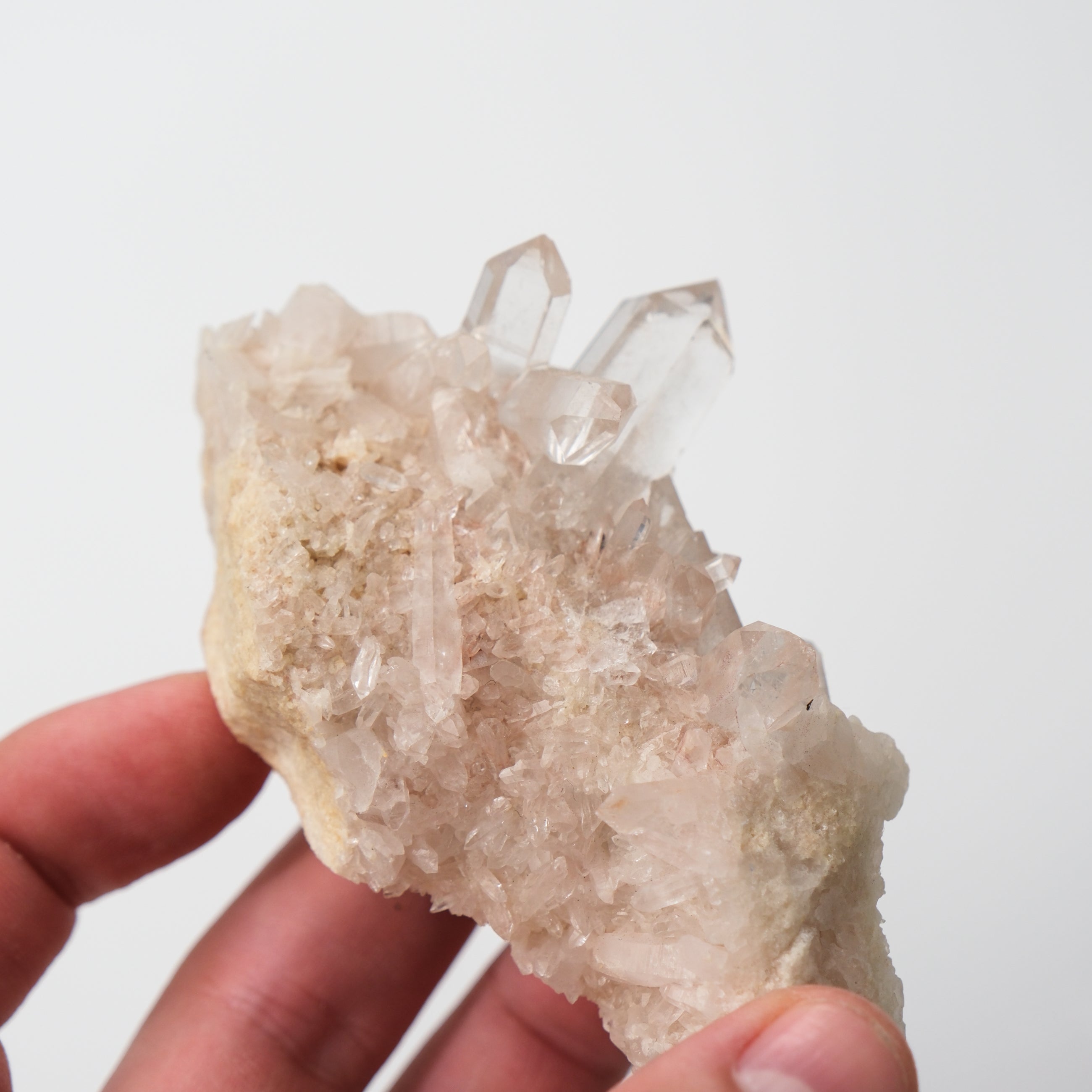Himalayan quartz crystal cluster from Noctis Studio with clear, sparkling quartz points arranged naturally on a base.