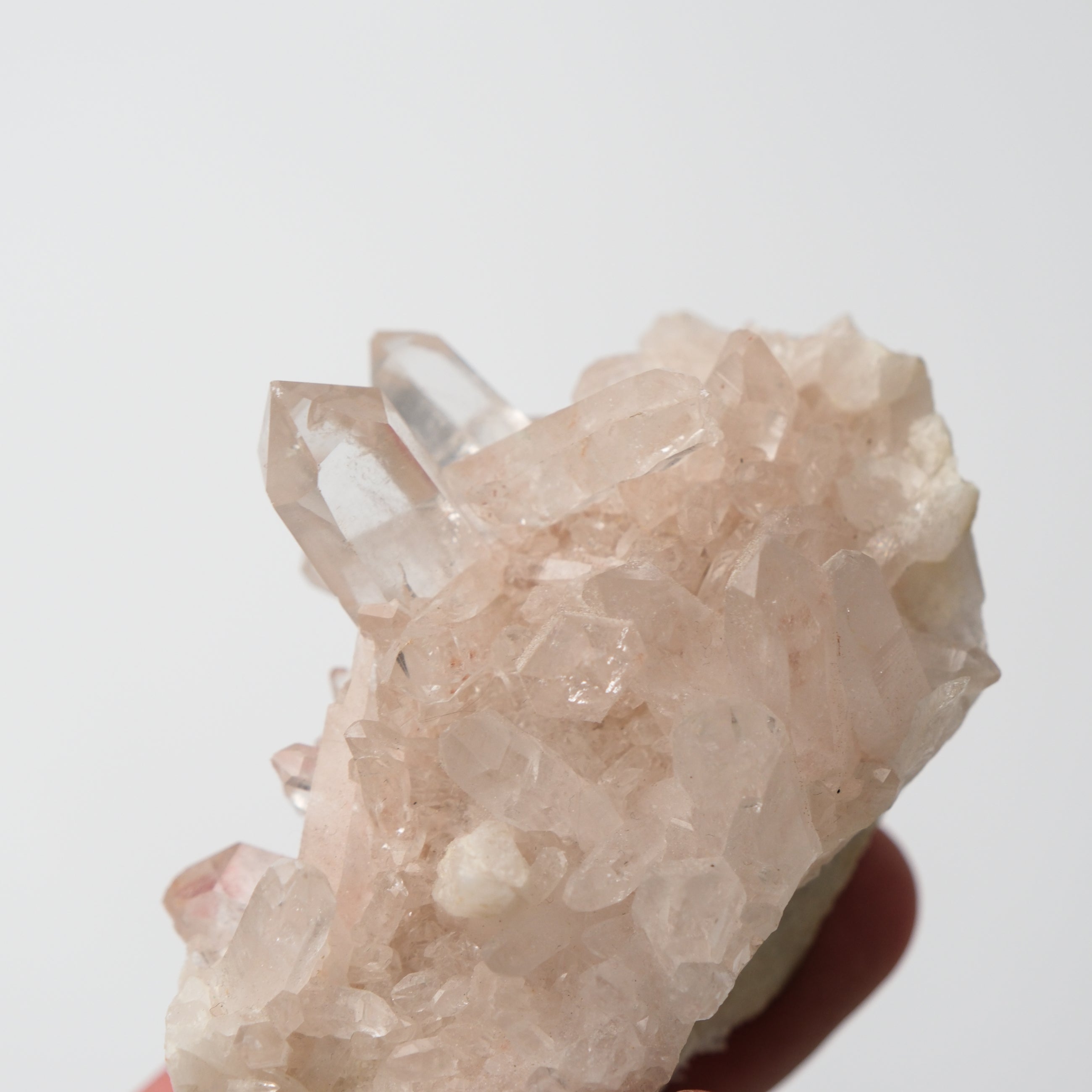 Himalayan quartz cluster from Noctis Studio displaying translucent, crystalline formations on a natural mineral base.