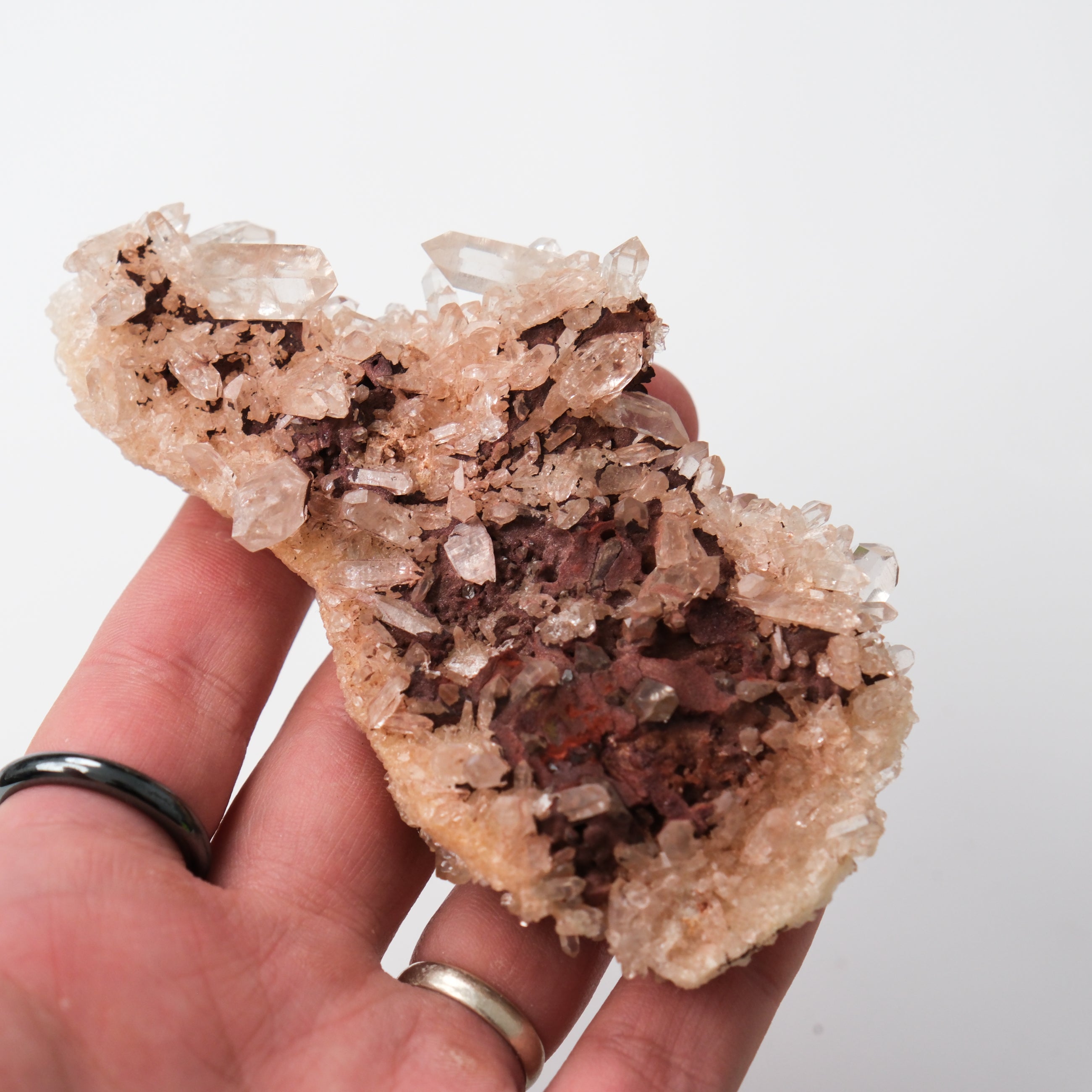 Himalayan quartz cluster with clear and pink crystals, natural mineral formation, displayed on a neutral background.