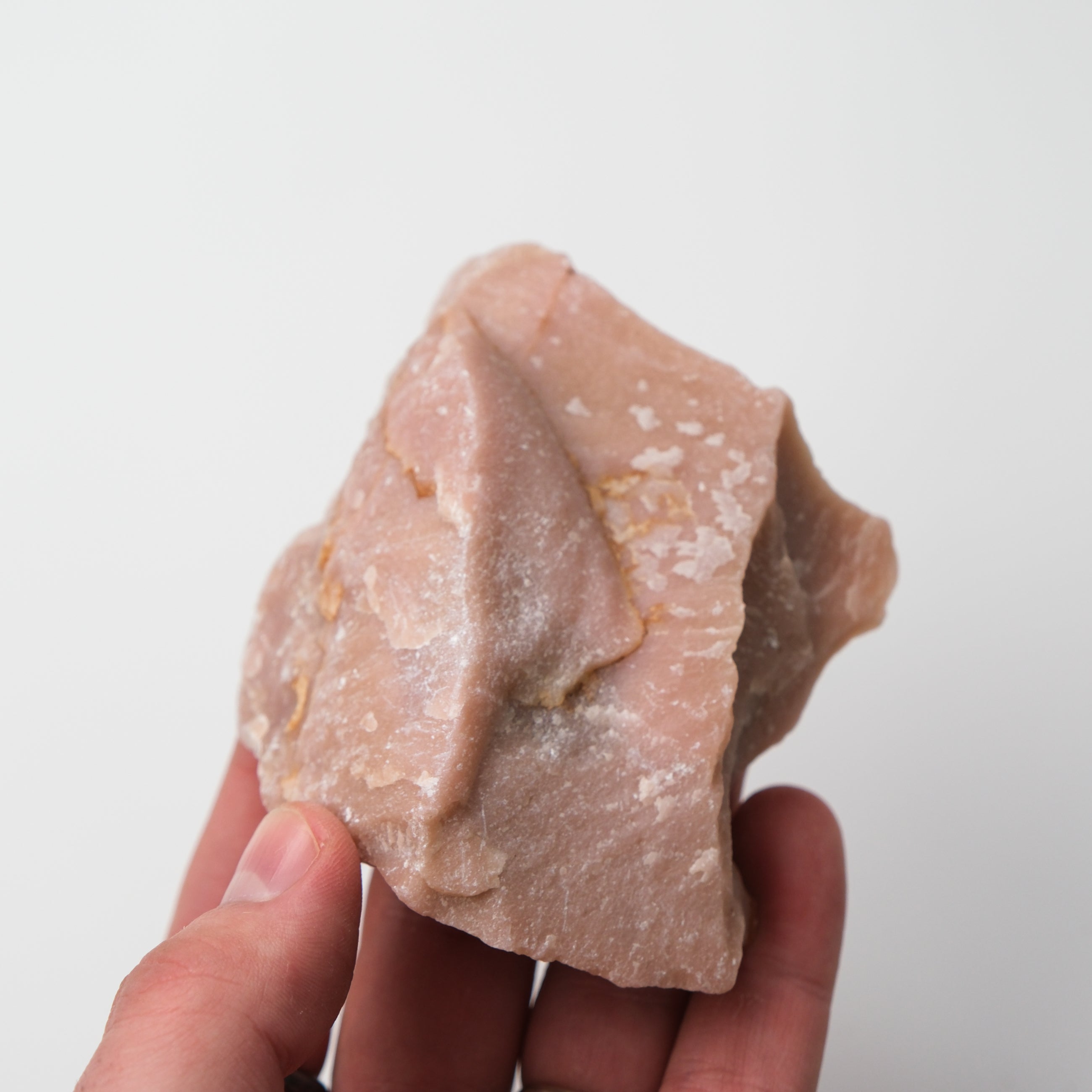 Pink Opal Rough gemstone from Noctis Studio with a vibrant pink, unpolished surface showcasing natural mineral textures.