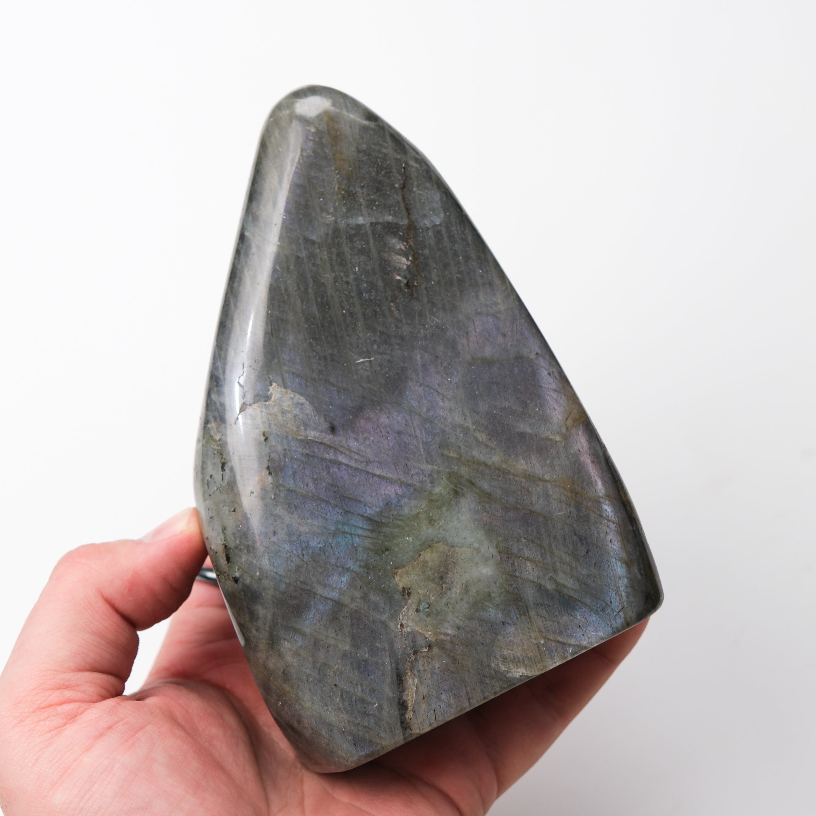 Labradorite freeform pillar gemstone from Noctis Studio, showcasing iridescent blue and green hues with polished, natural shape.