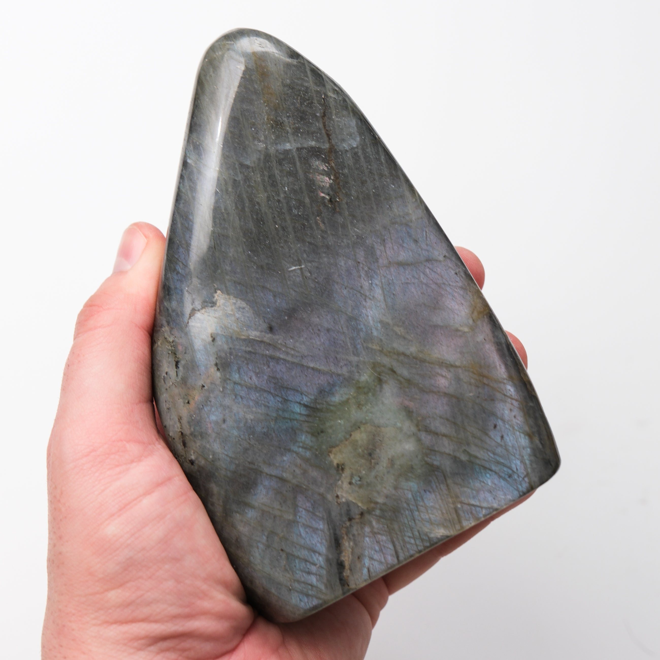 Labradorite freeform pillar gemstone from Noctis Studio, showcasing iridescent blue and green flashes in a polished stone.