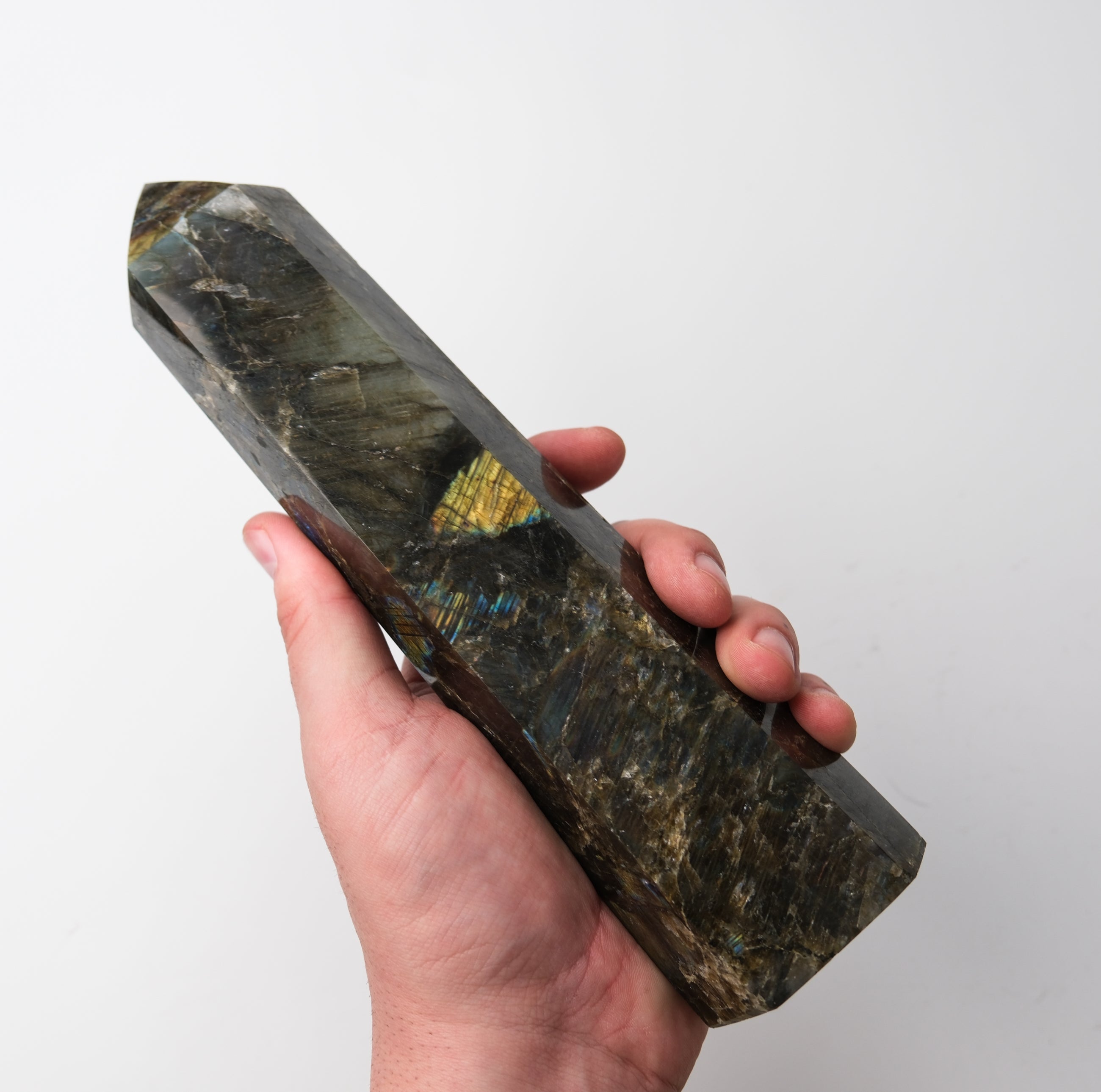 Labradorite pillar sculpture by Noctis Studio showcasing iridescent gray and blue hues with a polished, smooth surface.