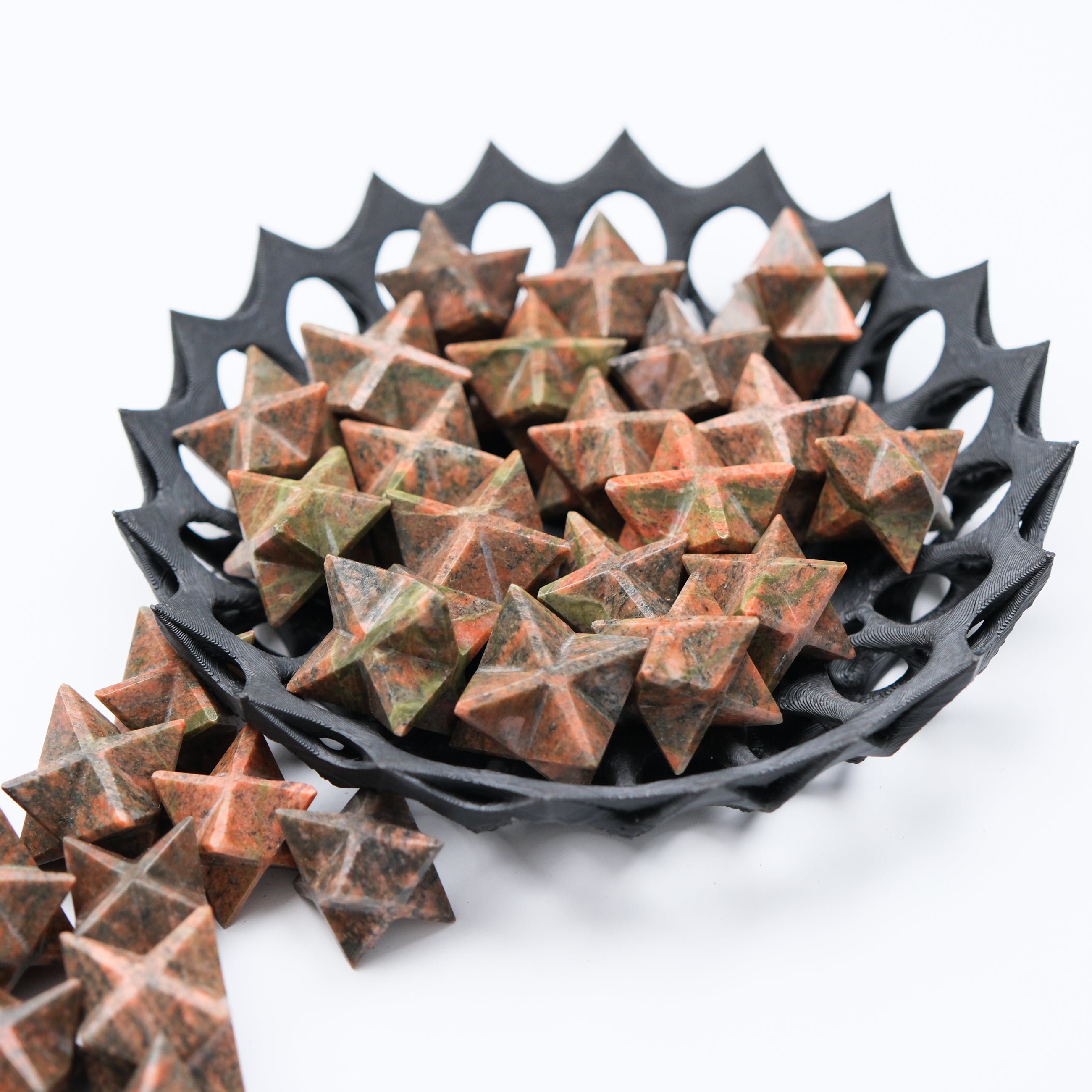 Unakite star gemstone from Noctis Studio, featuring a polished star-shaped unakite mineral with green and pink hues.