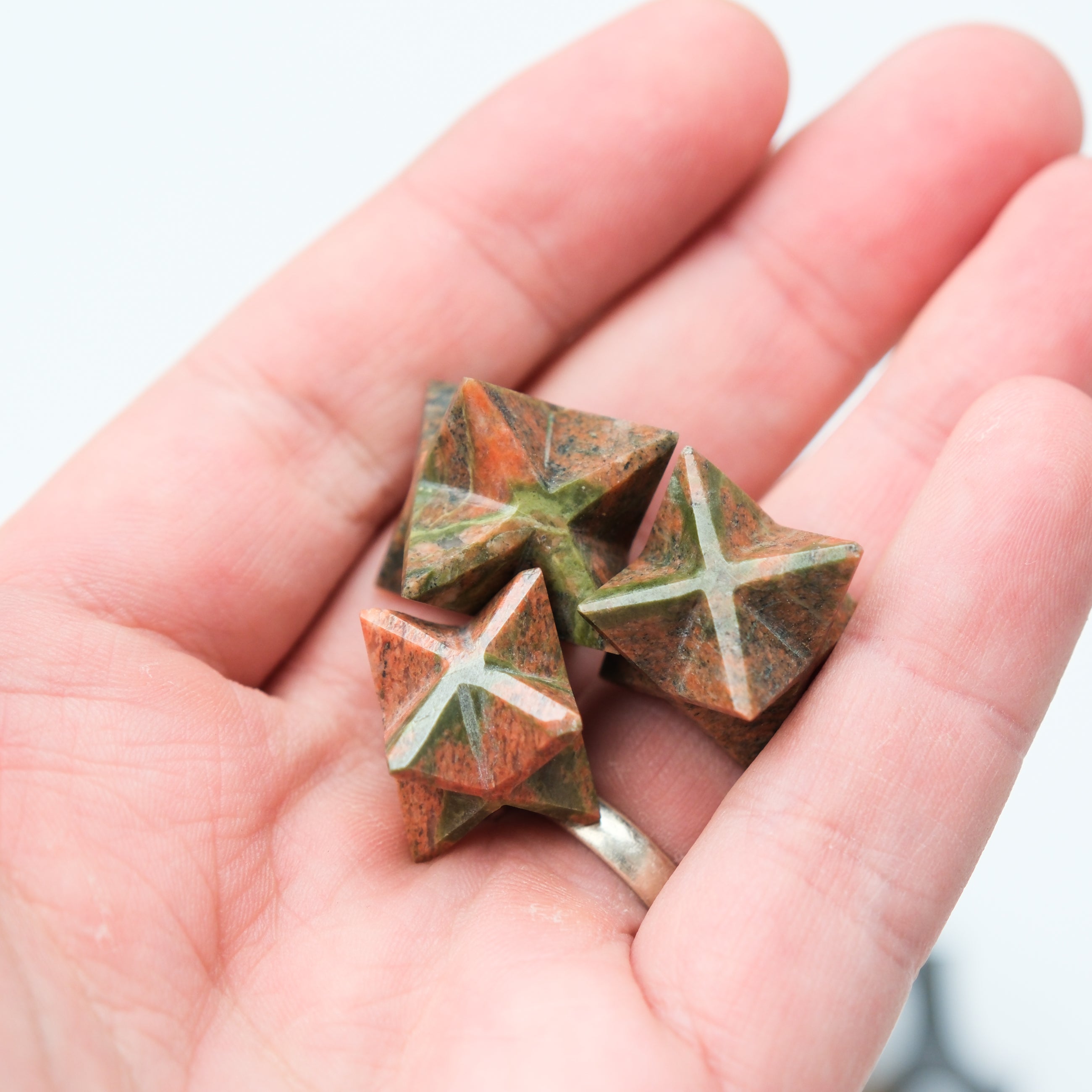 Unakite star-shaped gemstone from Noctis Studio with polished surface and vibrant green and pink mineral patterns.