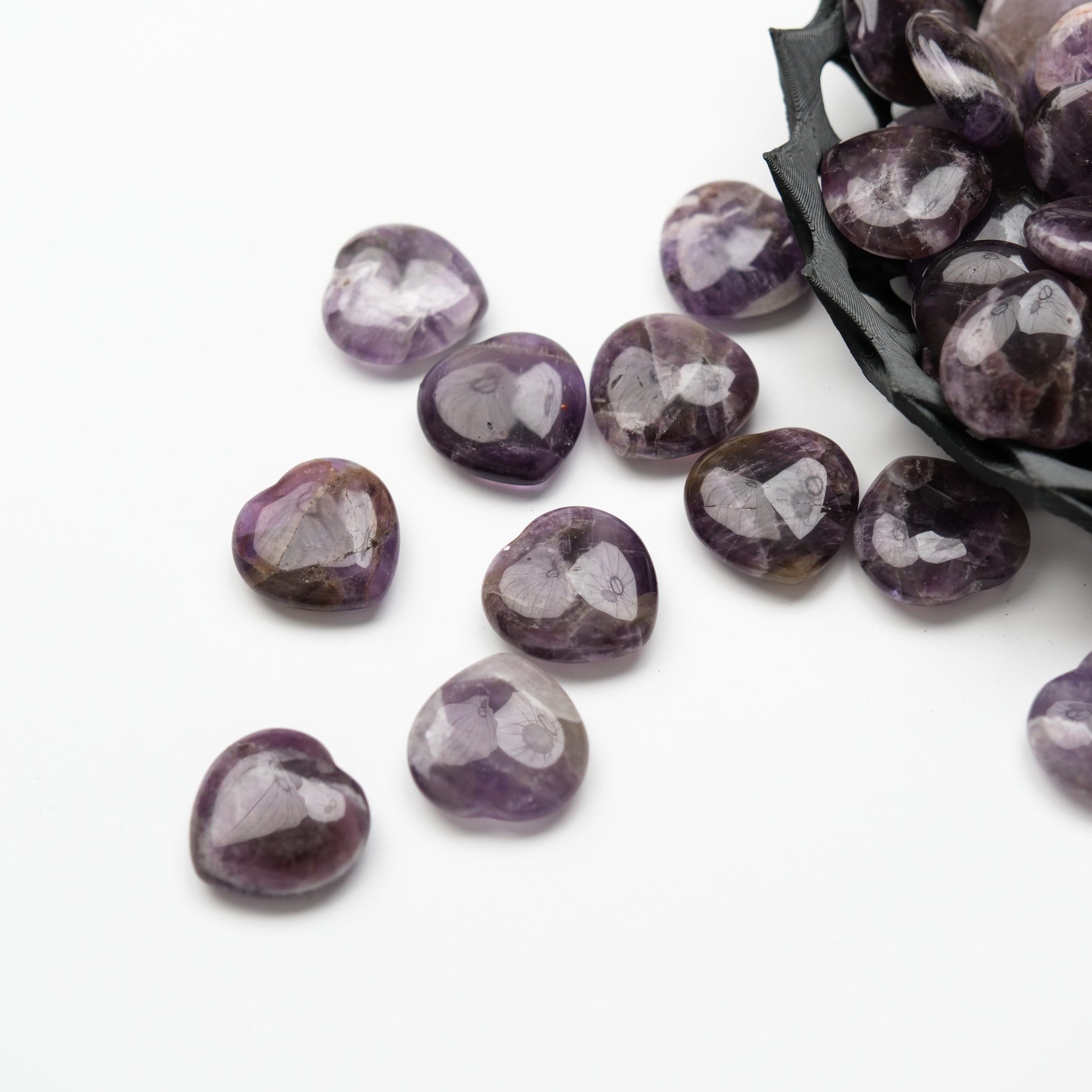 Small amethyst heart pendant by Noctis Studio, featuring a polished purple gemstone in a heart shape.