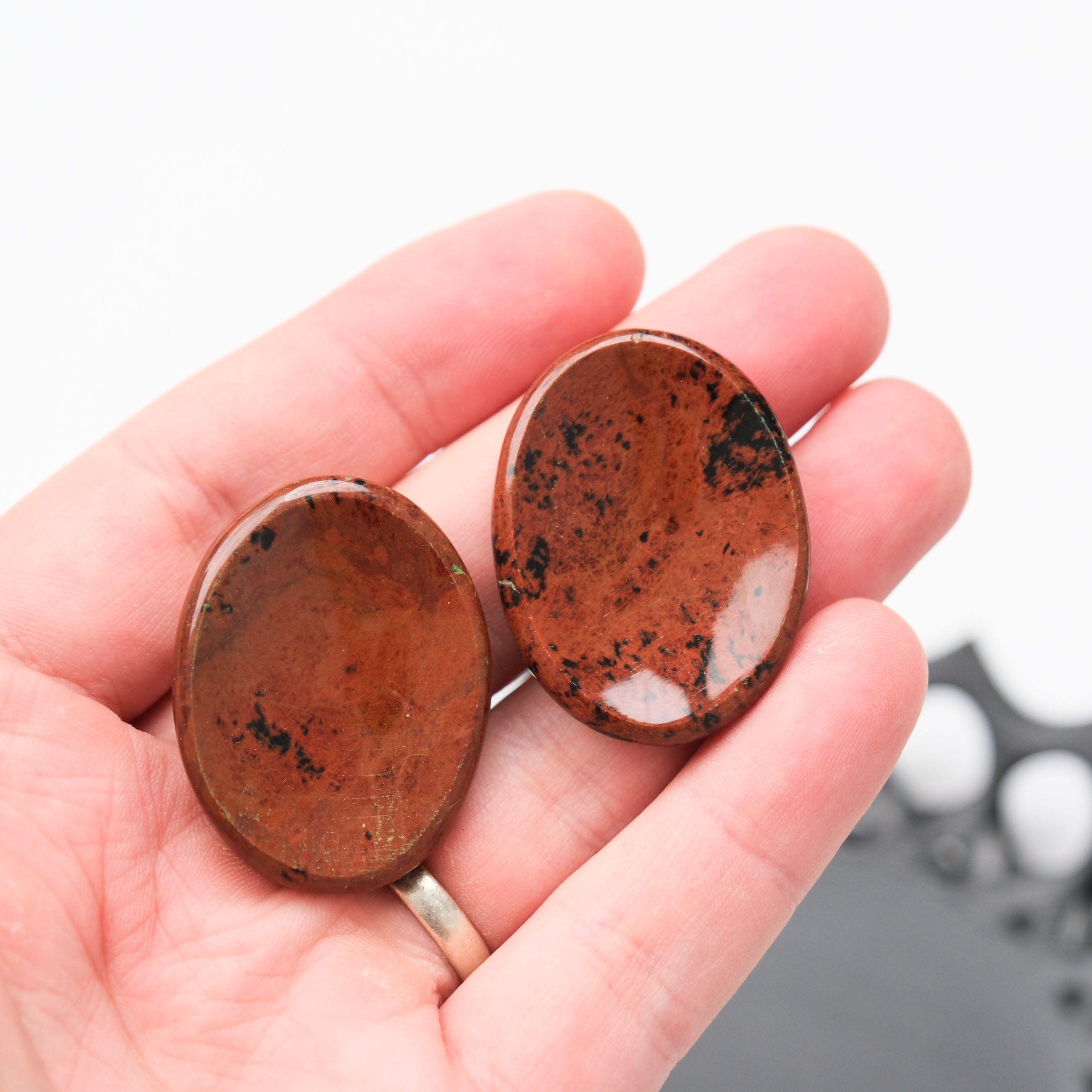 Mahogany Obsidian worry stone from Noctis Studio, smooth polished gemstone for meditation and stress relief.