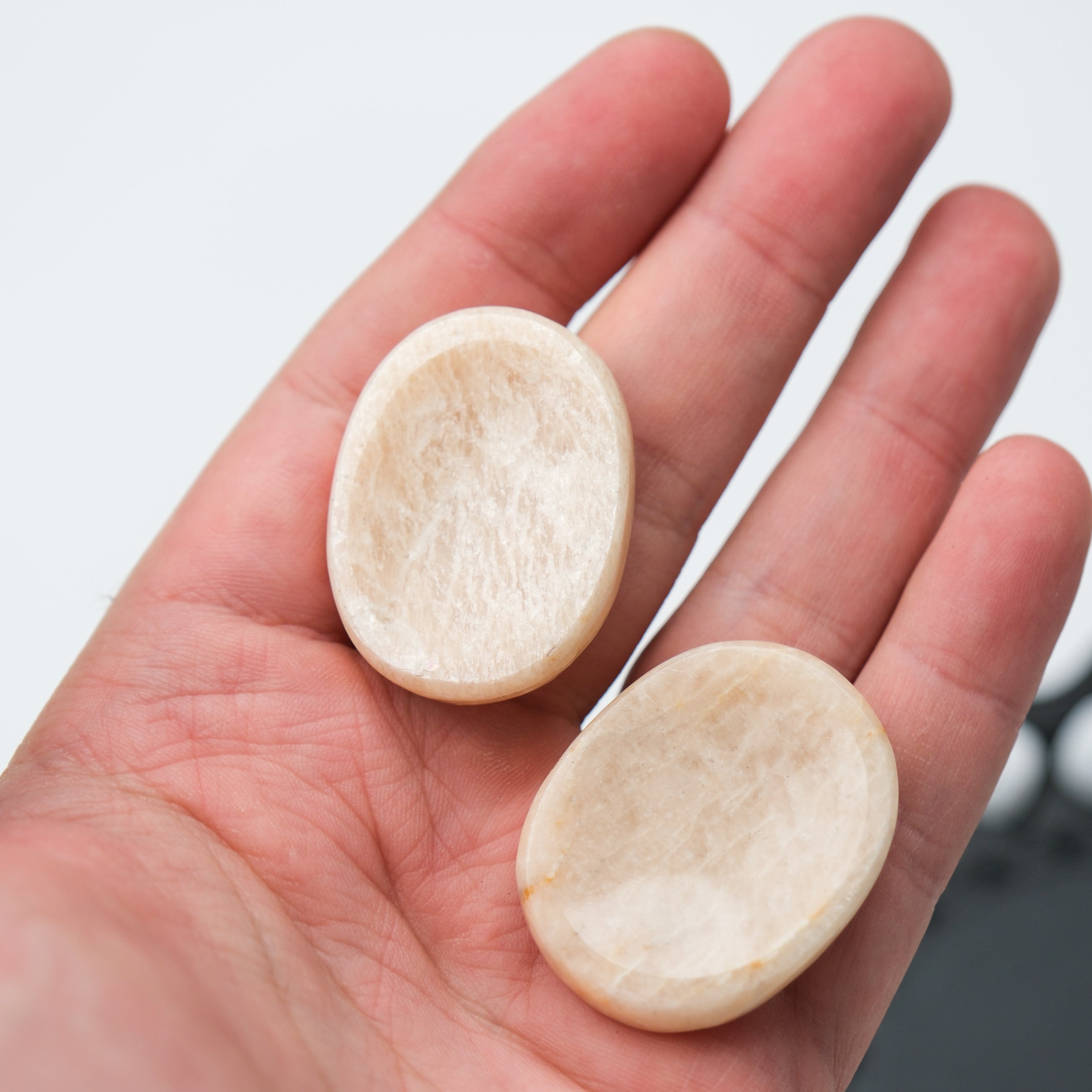 Cream moonstone worry stone from Noctis Studio, smooth polished gemstone with a gentle, calming appearance.