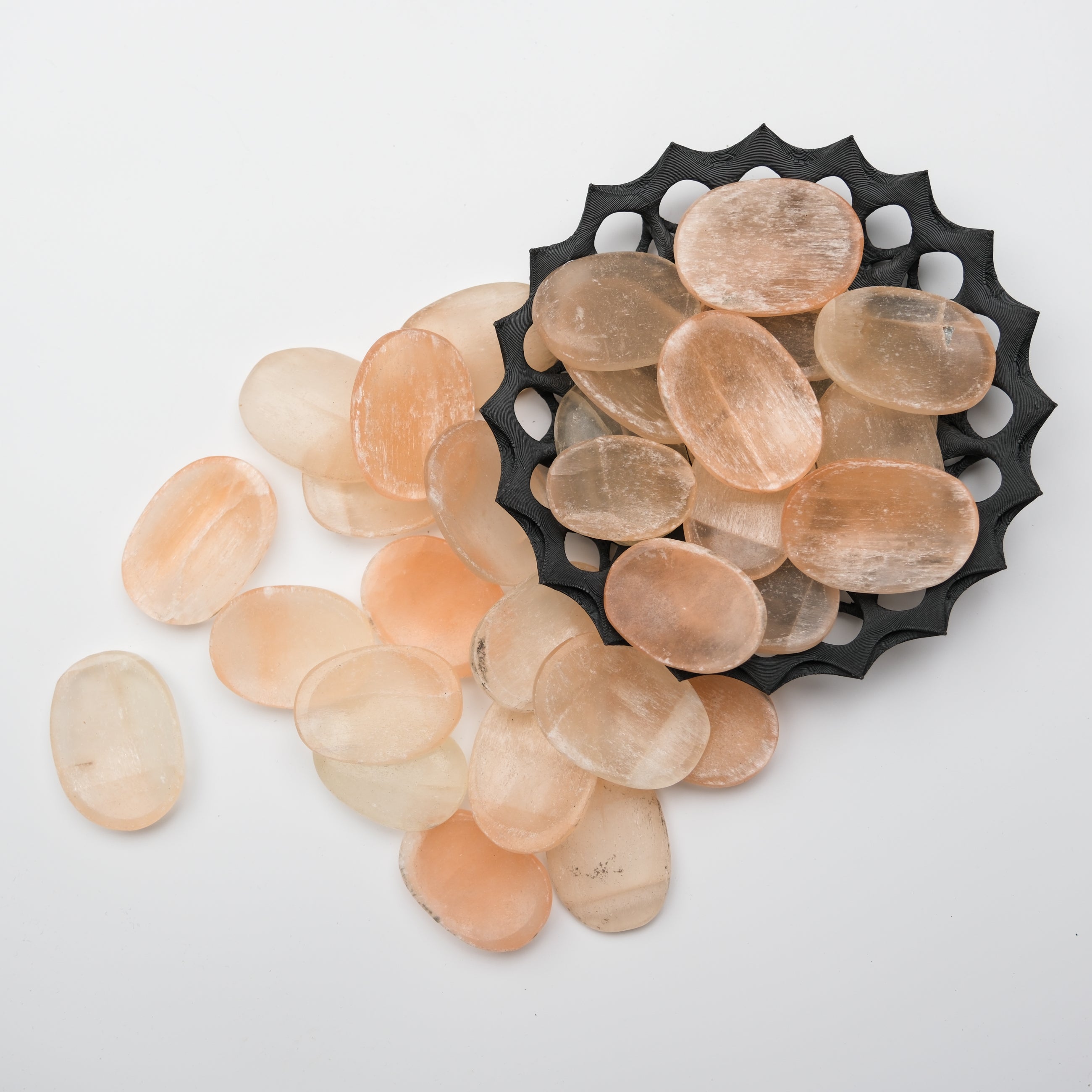 Orange Selenite worry stone from Noctis Studio, smooth polished crystal with a rounded shape, ideal for stress relief and meditation.
