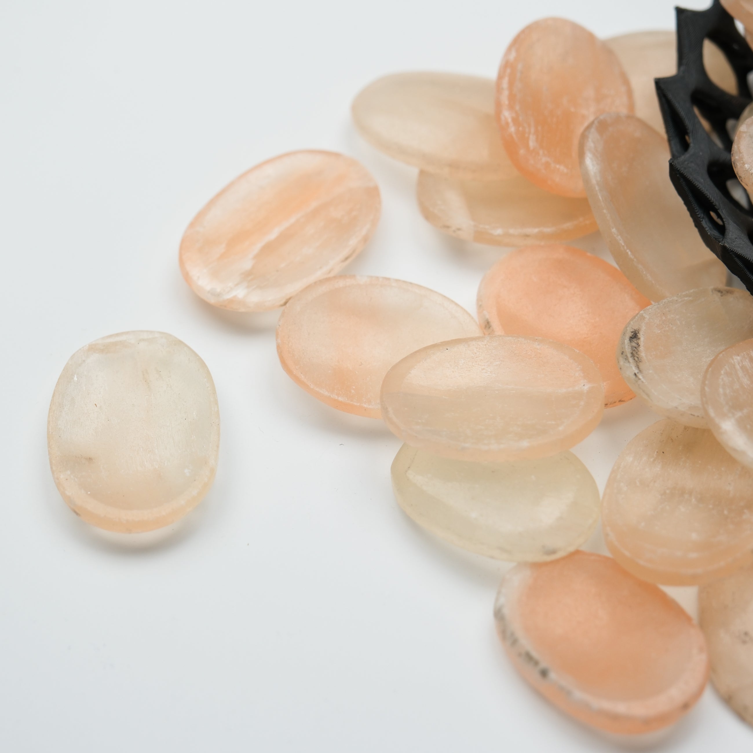 Orange Selenite worry stone from Noctis Studio with smooth, polished surface and rounded shape, ideal for calming and stress relief.