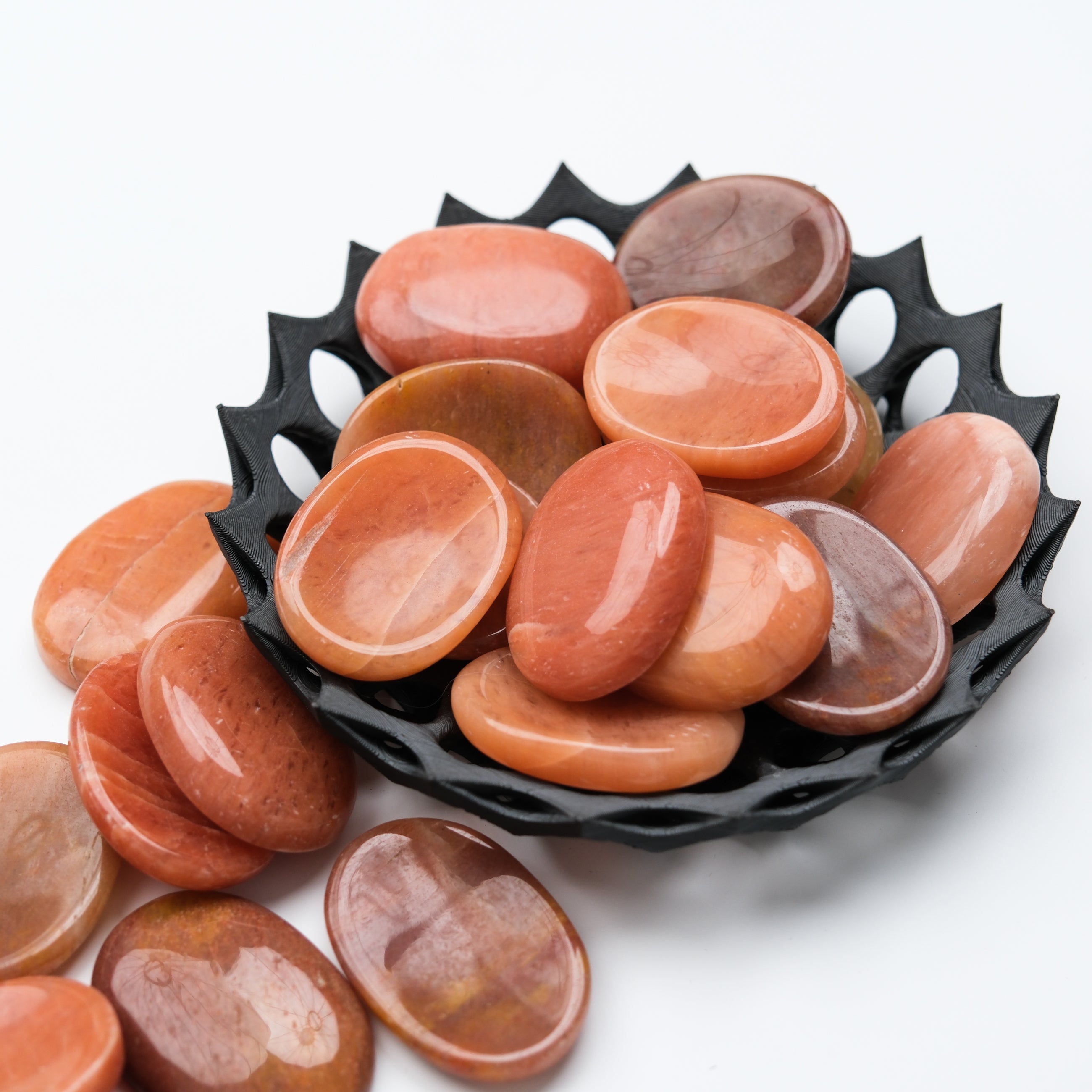 Peach aventurine worry stone from Noctis Studio with smooth, polished surface and rounded shape for stress relief.