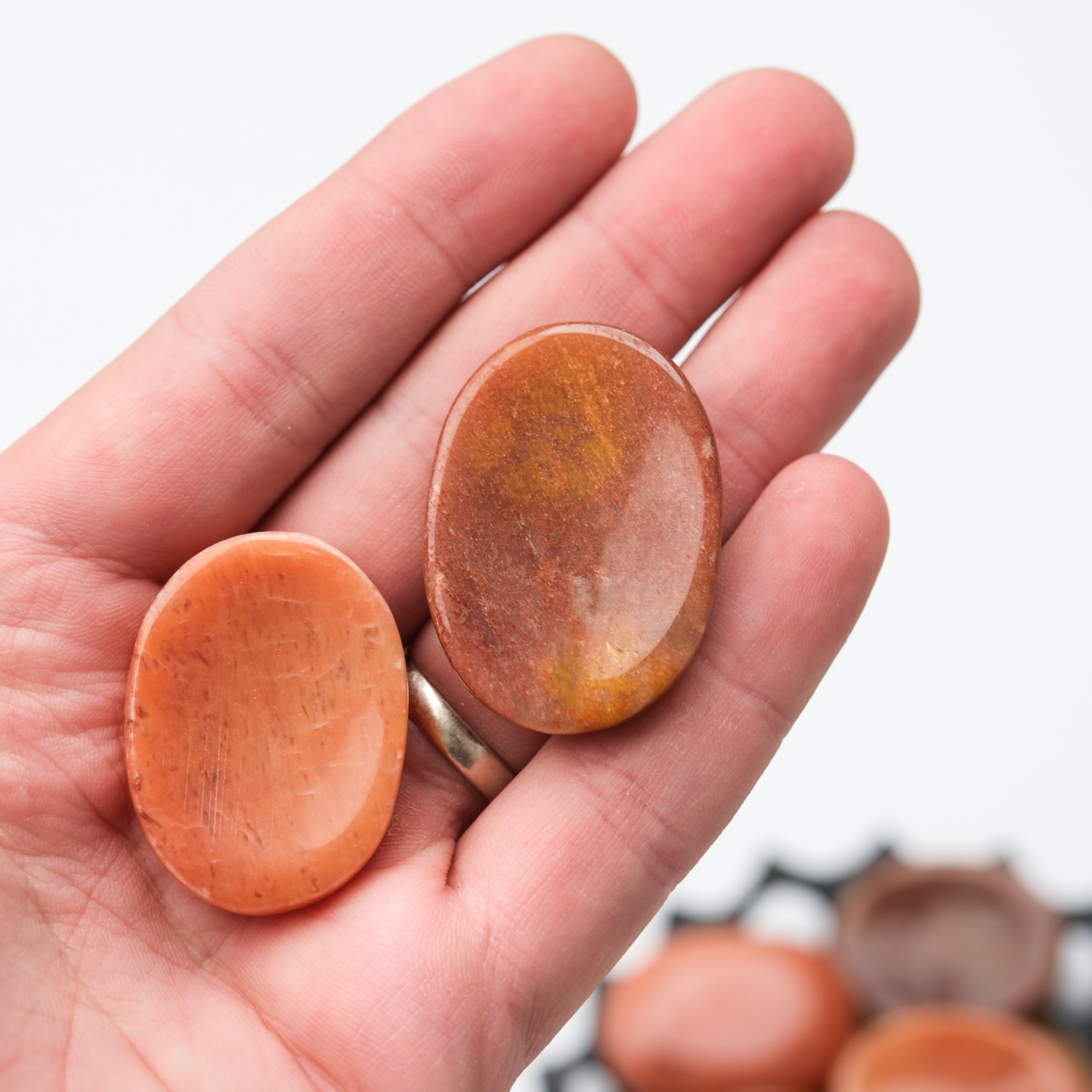 Peach aventurine worry stone from Noctis Studio with smooth, polished surface and rounded shape for stress relief.