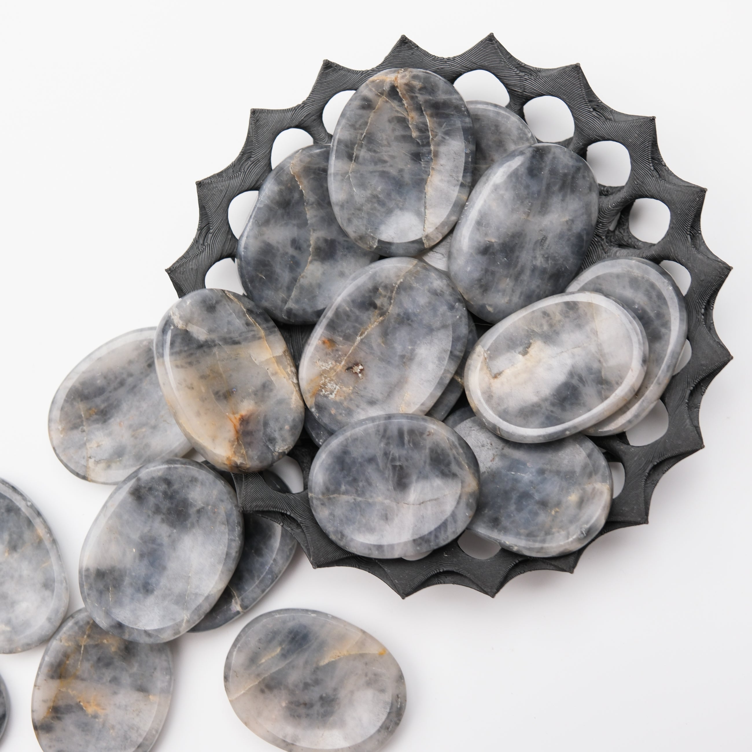Iolite worry stone from Noctis Studio, smooth polished gemstone for calming and stress relief, shown on a neutral background.