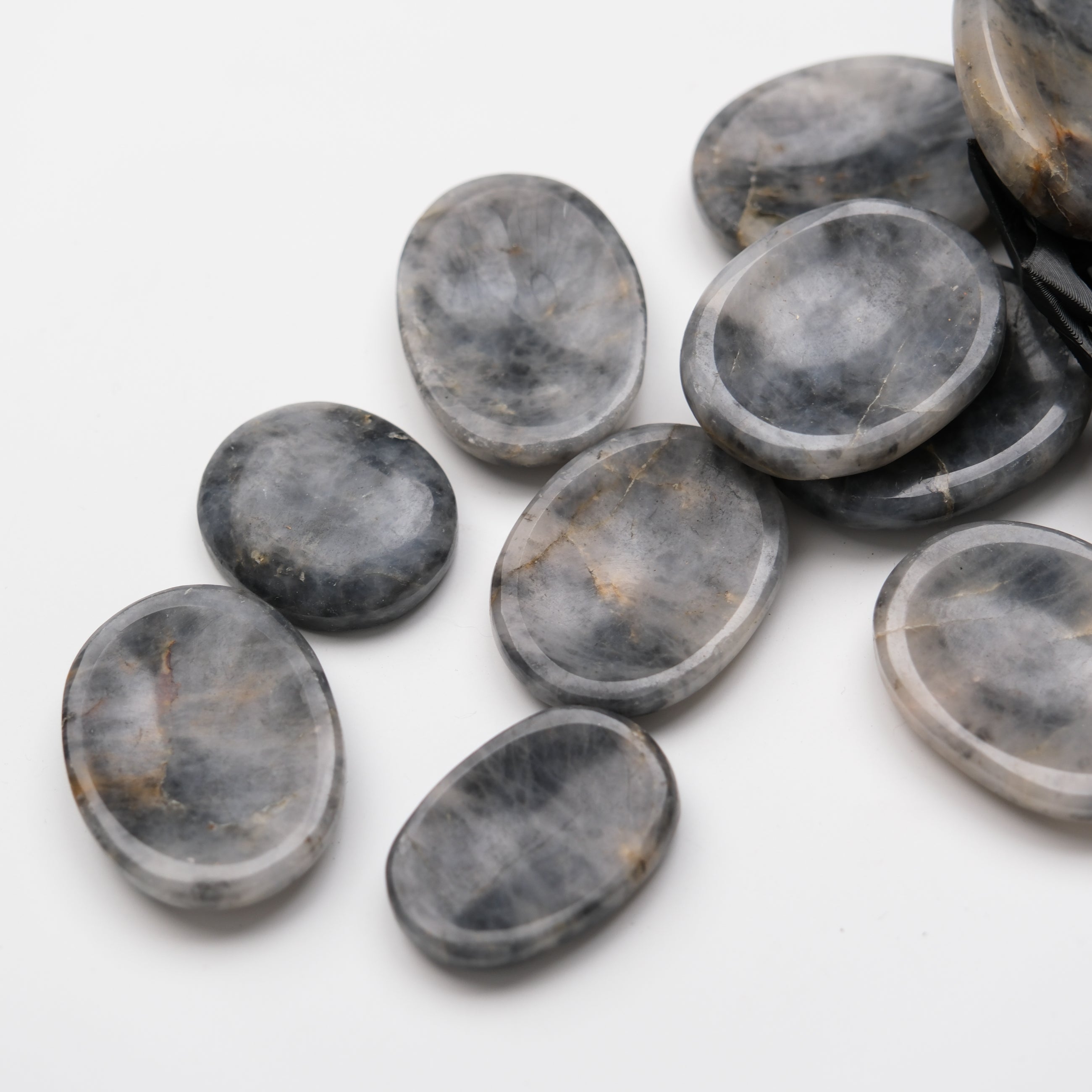 Iolite worry stone from Noctis Studio, smooth polished gemstone for stress relief and meditation, shown in close-up image.