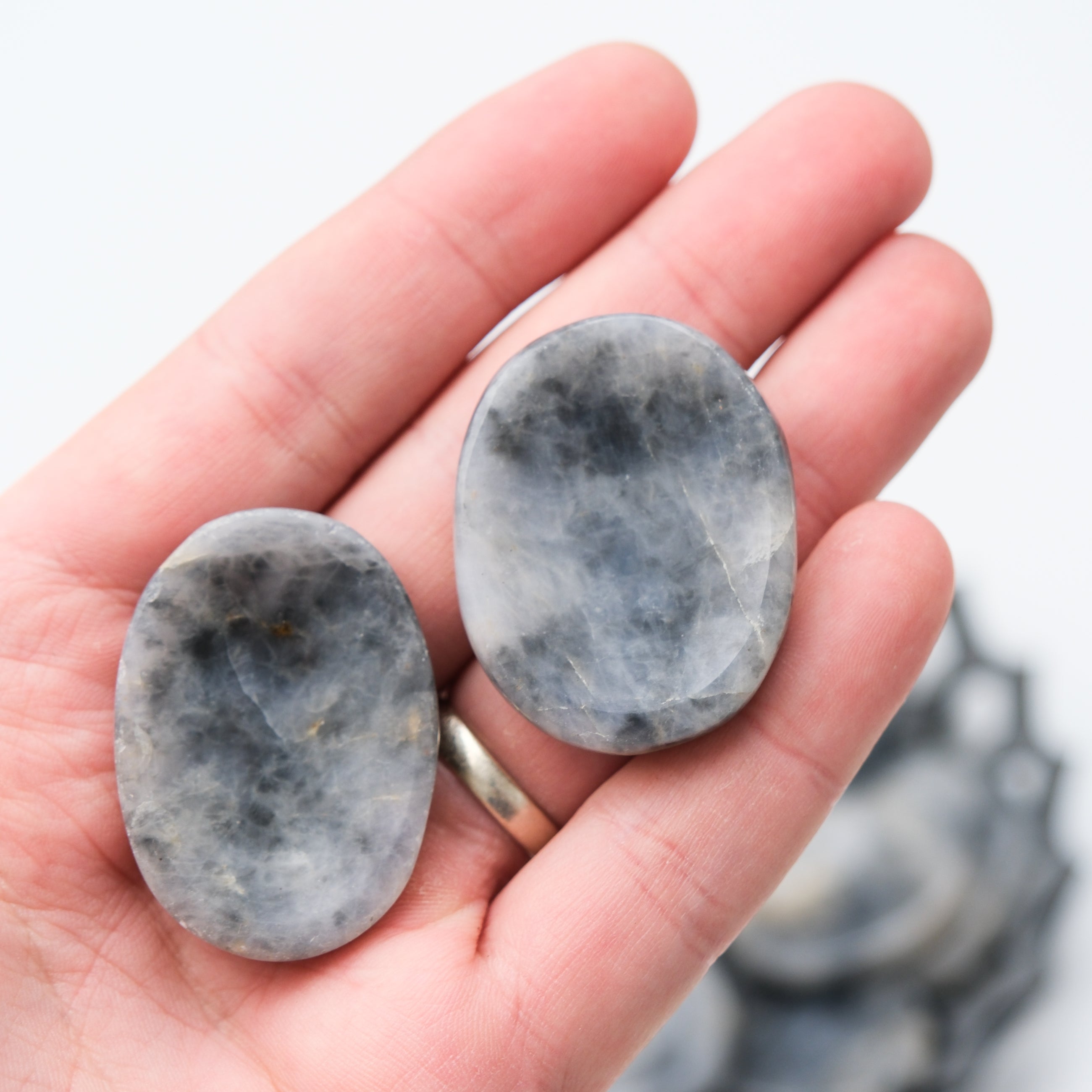 Iolite worry stone from Noctis Studio, smooth polished gemstone for stress relief and calming gestures.