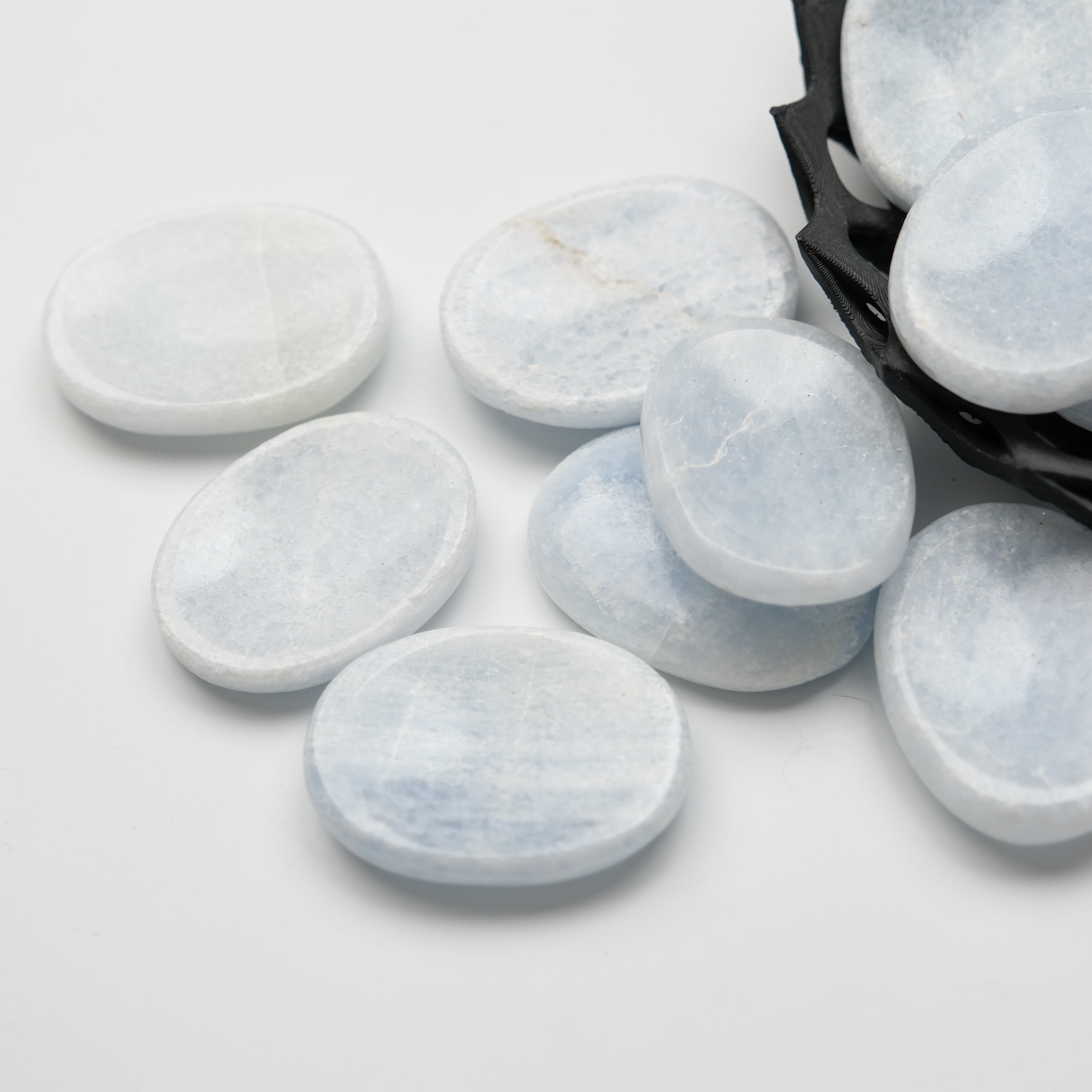 Blue calcite worry stone from Noctis Studio with smooth, polished surface and rounded shape, ideal for meditation and stress relief.