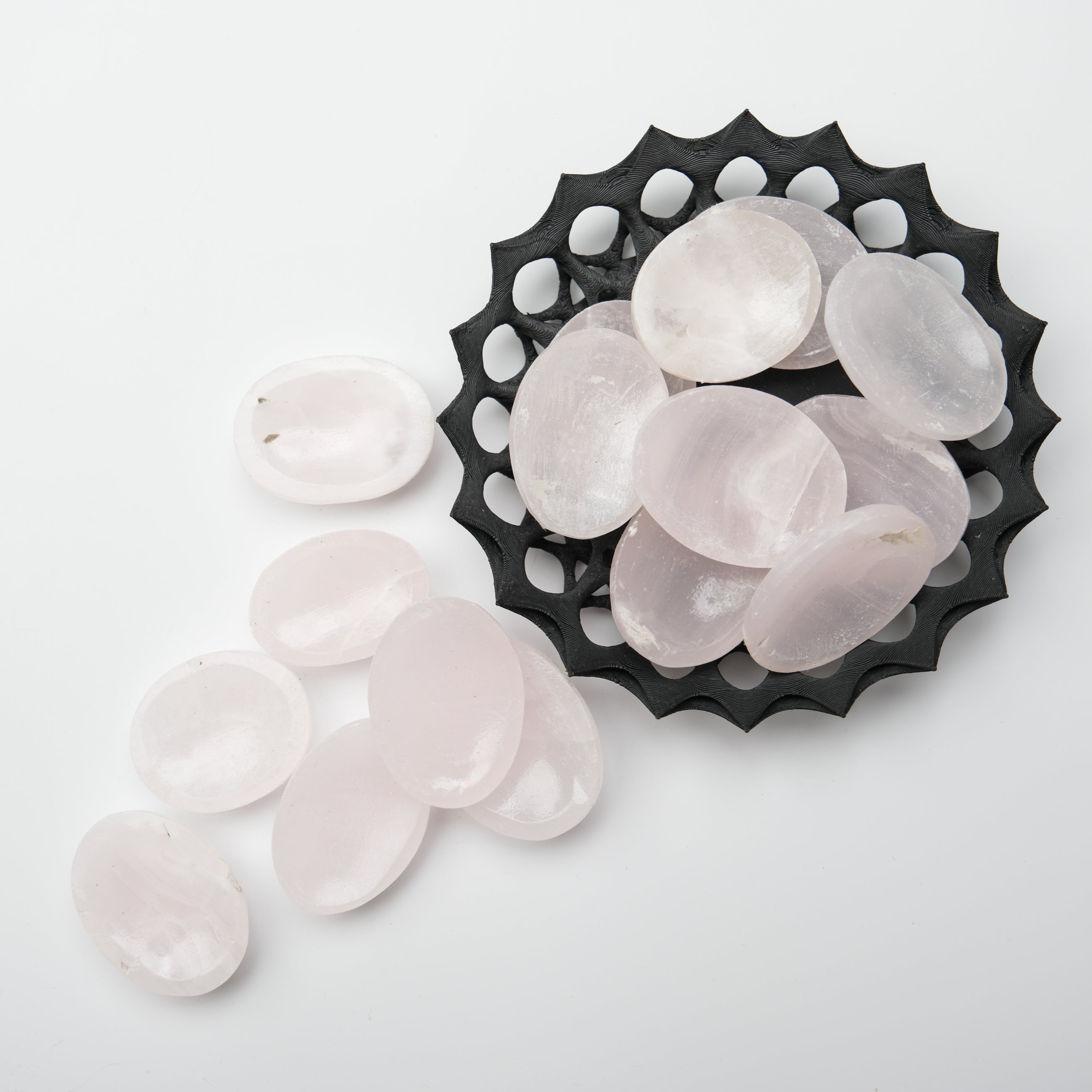 Mangano calcite worry stone from Noctis Studio, smooth oval-shaped gemstone for stress relief and calming meditation.