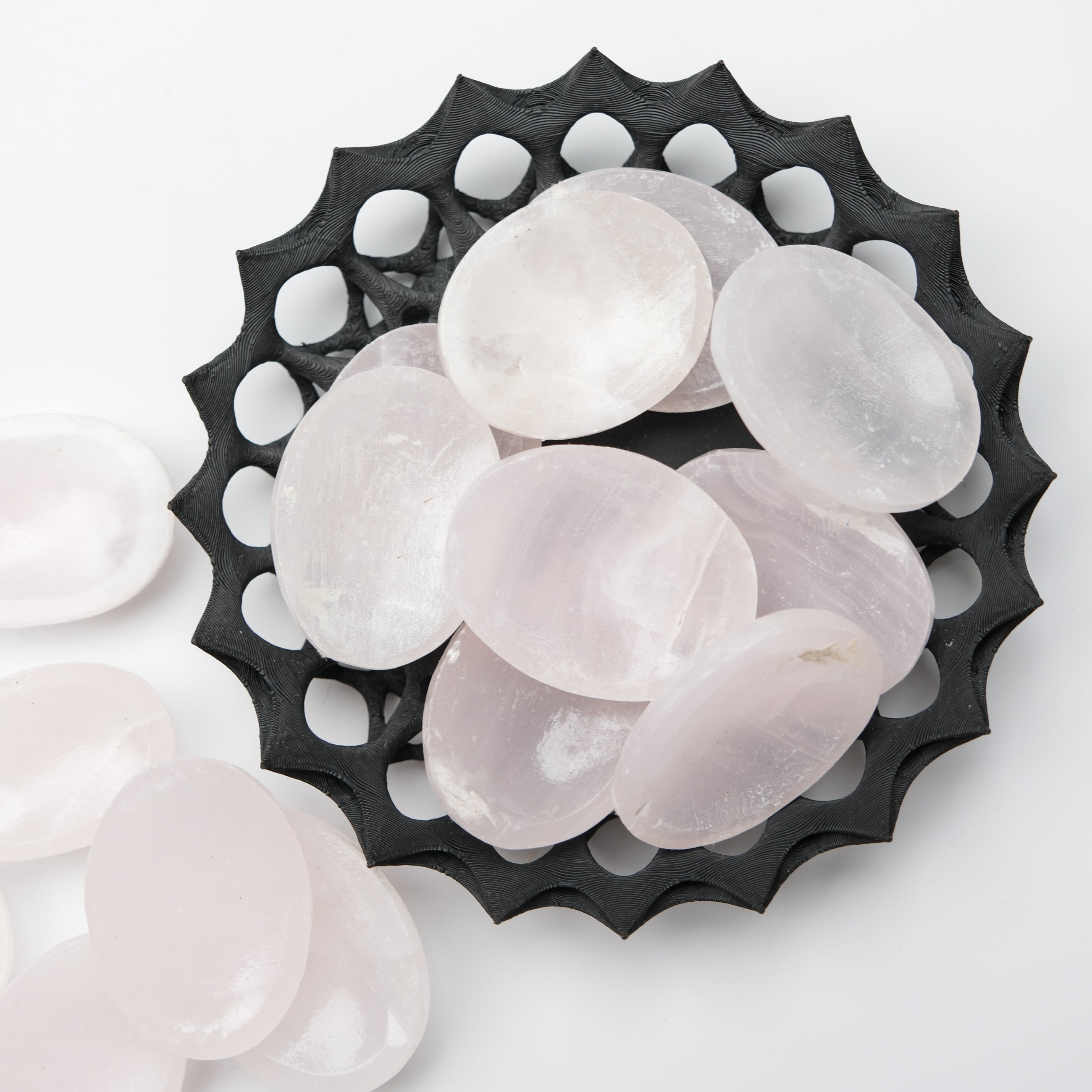 Mangano calcite worry stone from Noctis Studio, smooth polished gemstone for stress relief and meditation.