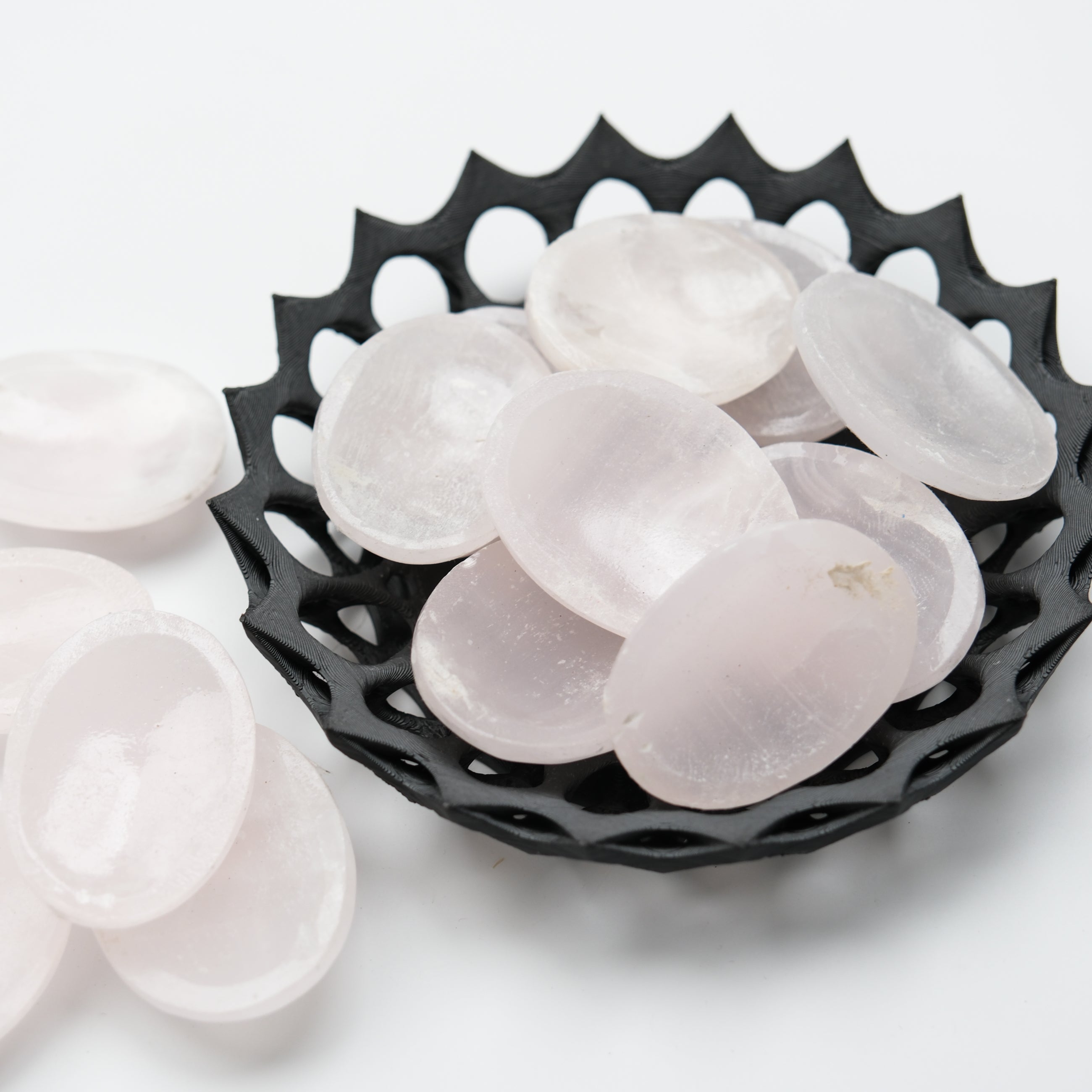 Mangano calcite worry stone from Noctis Studio showing smooth, polished pink mineral with natural patterns and rounded shape for meditation.