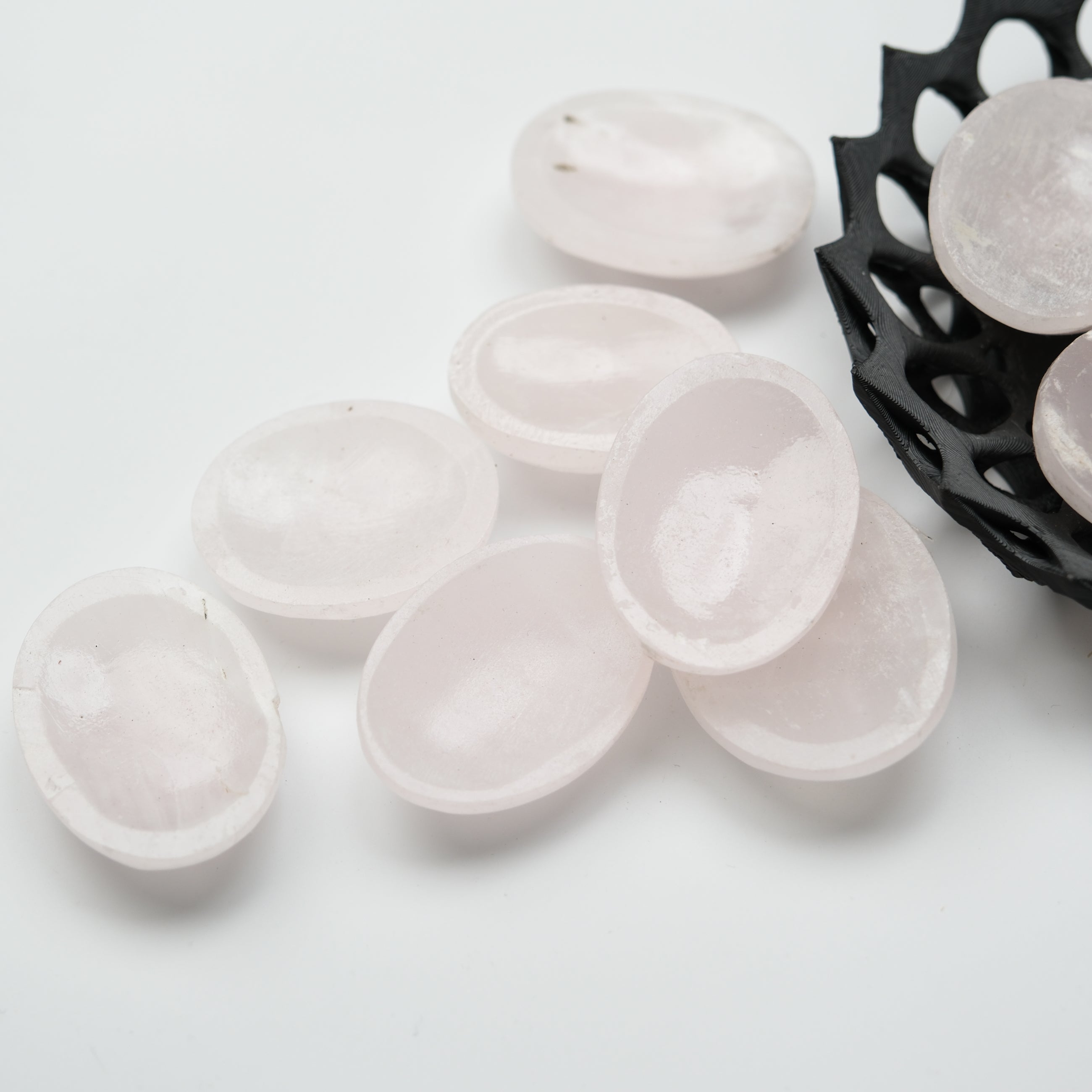 Mangano Calcite worry stone from Noctis Studio featuring smooth, polished pink mineral for stress relief and calming gestures.