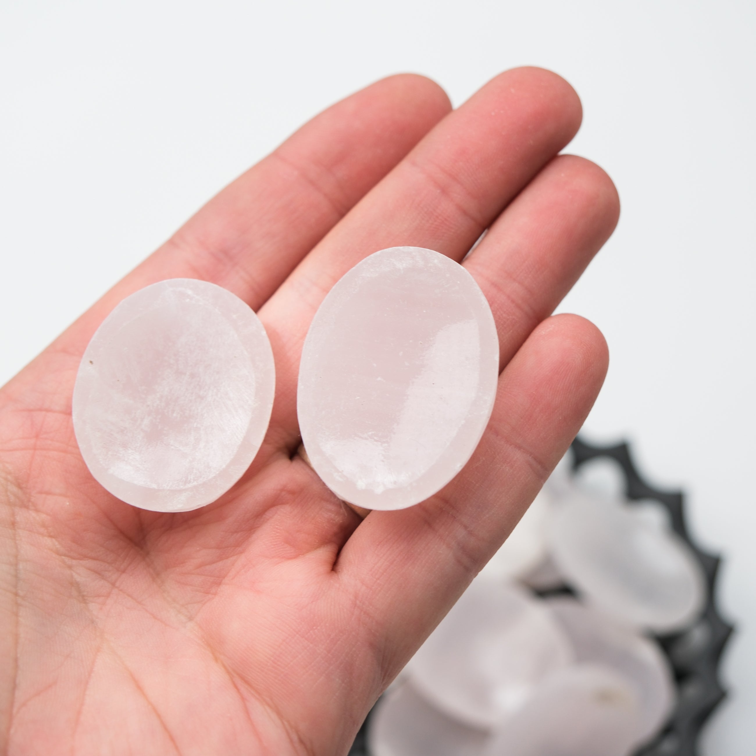 Mangano calcite worry stone by Noctis Studio showing smooth, polished pink mineral with gentle curves and natural texture.