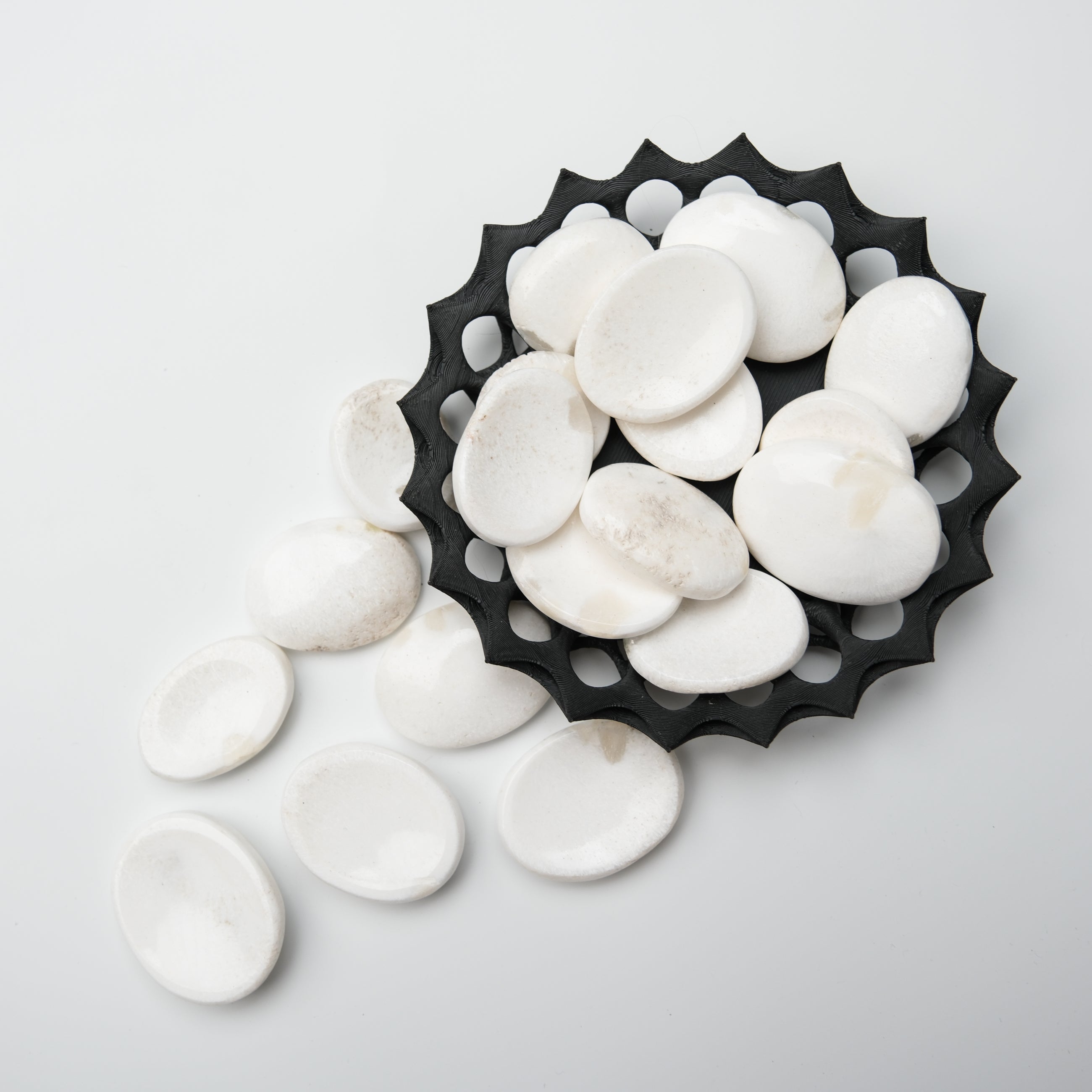 Scolecite worry stone from Noctis Studio, smooth polished gemstone with natural white and gray patterns, handheld meditation tool.